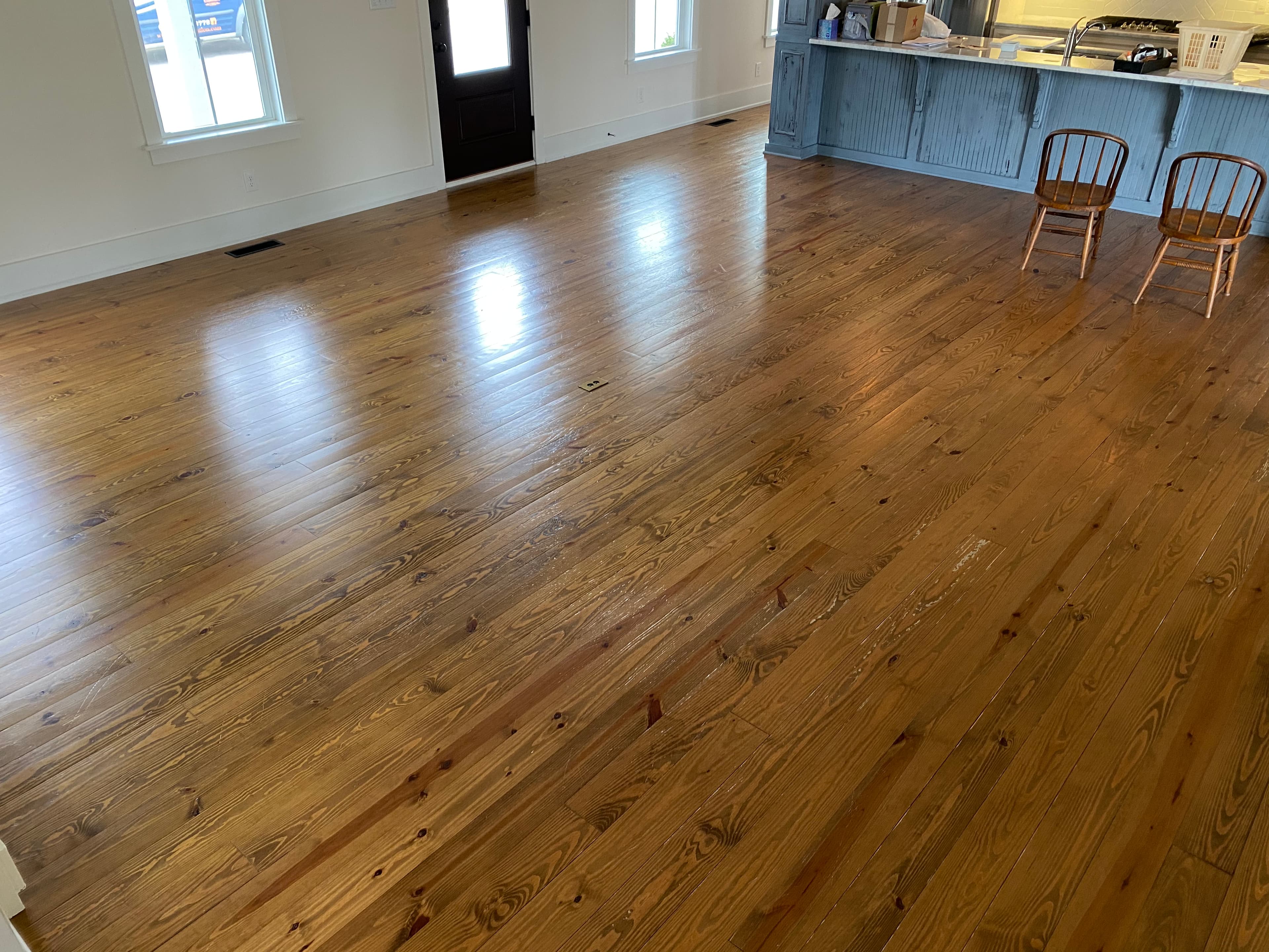 Wide yellow pine floors before refinishing in Flowers Plantation Clayton NC Oglethorpe Drive, worn finish with gapping visible throughout