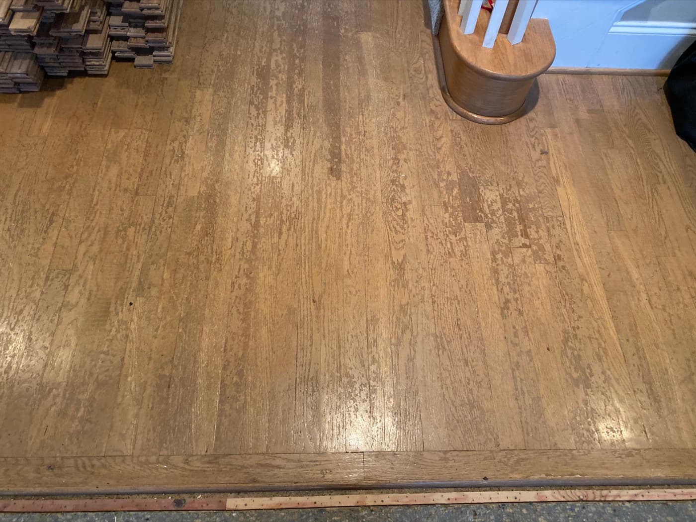 Existing 2.25-inch red oak hardwood floors in main level hallway before refinishing, Glen Laurel Clayton NC