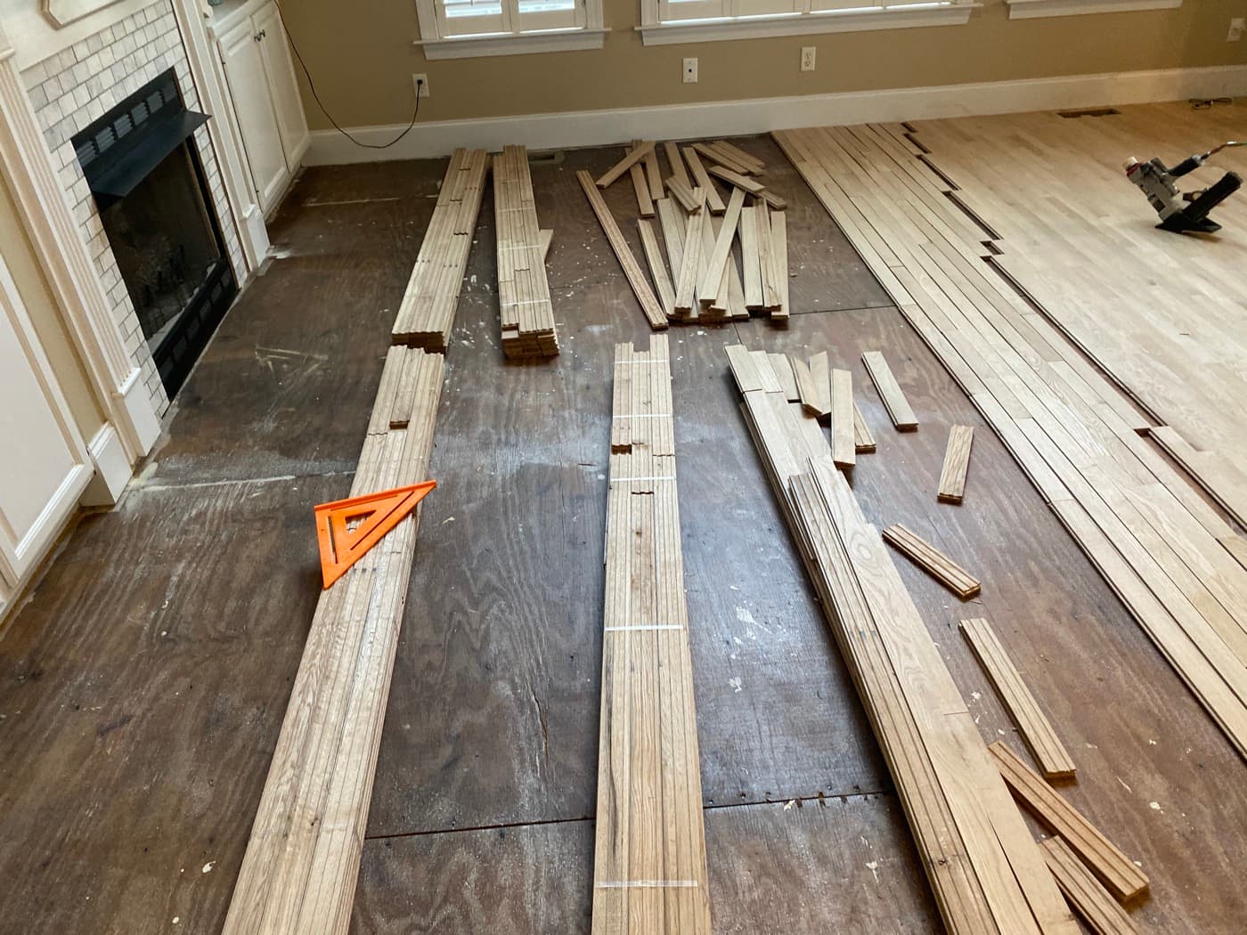 Herringbone hardwood installation in progress at fireplace hearth in Glen Laurel Clayton NC
