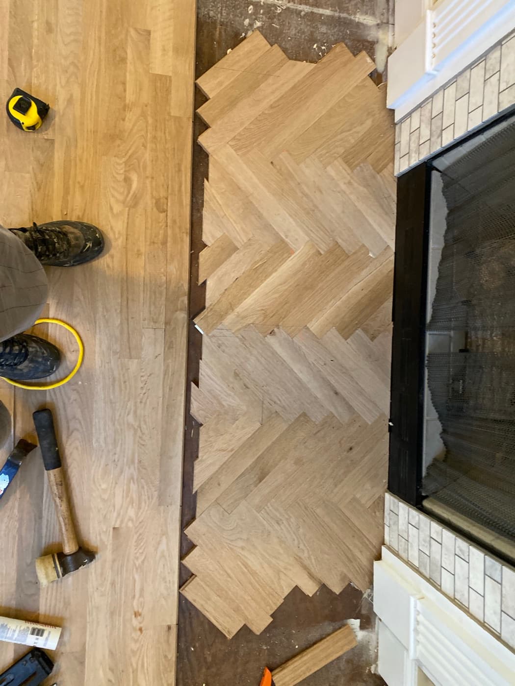 Herringbone red oak pattern at fireplace partially laid during installation in Glen Laurel Clayton NC