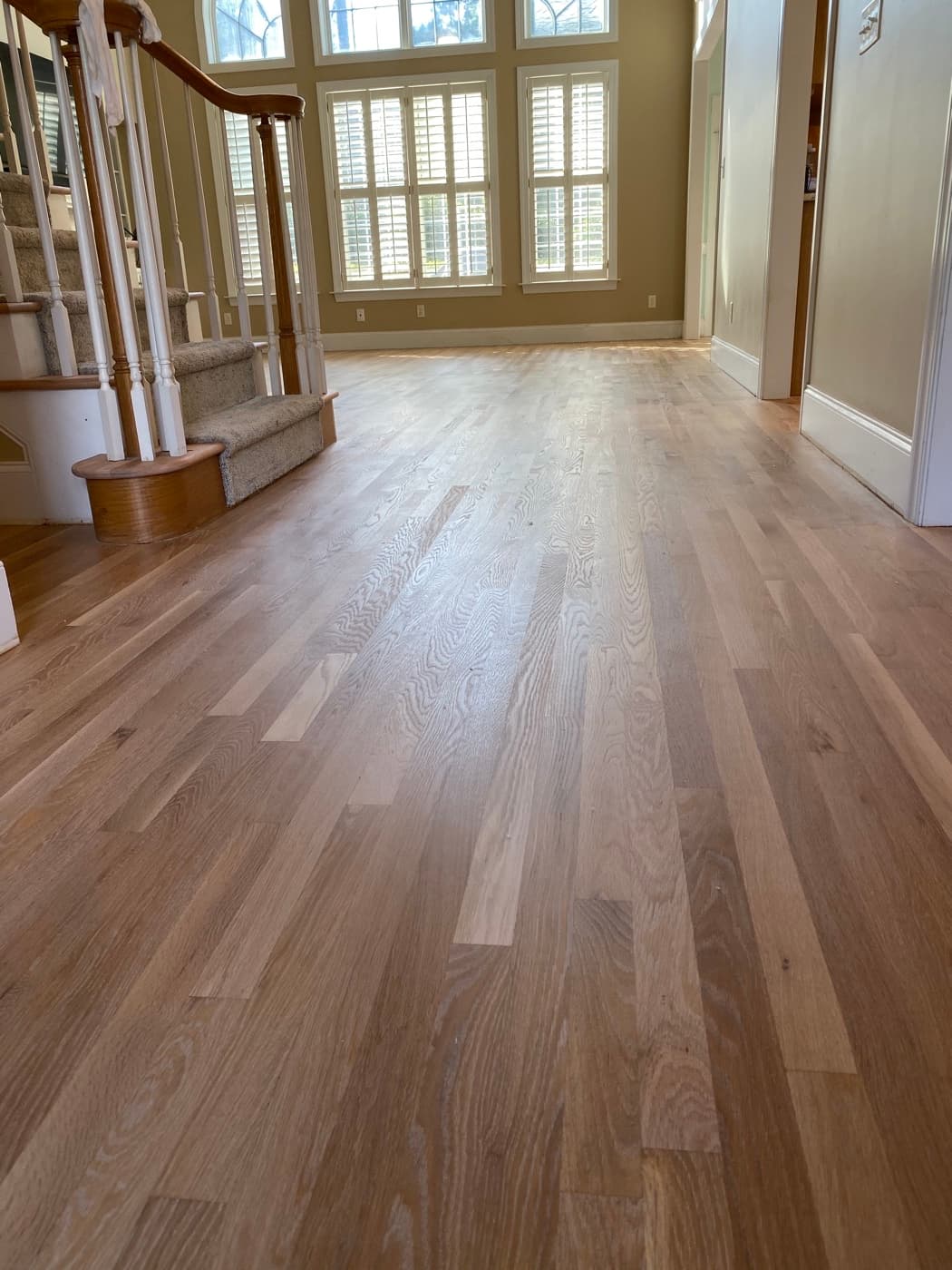 Red oak hardwood floors with natural hardwax oil finish in foyer and staircase Glen Laurel Clayton NC