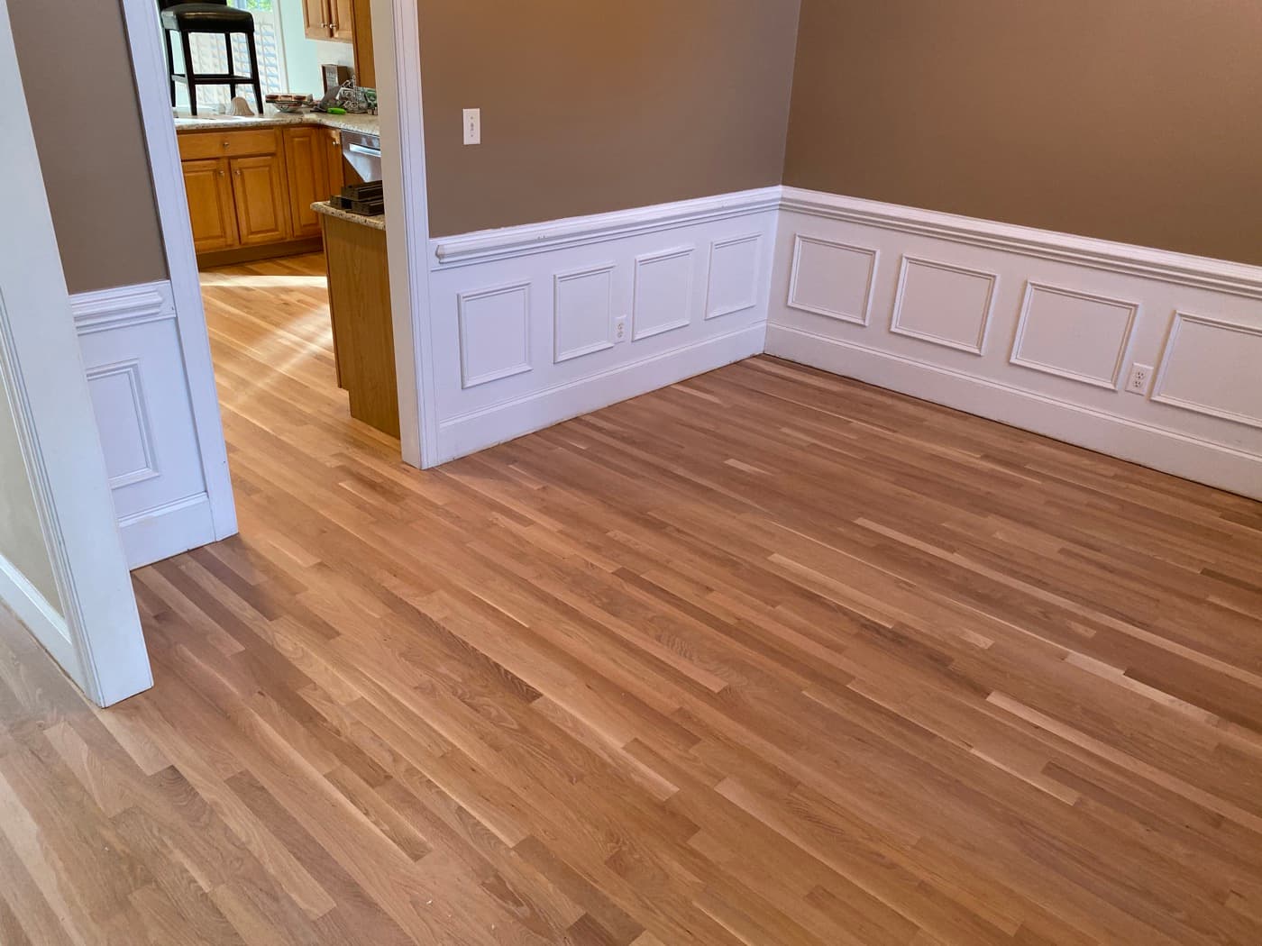 Red oak hardwood floors with natural hardwax oil finish in dining room with wainscoting Glen Laurel Clayton NC