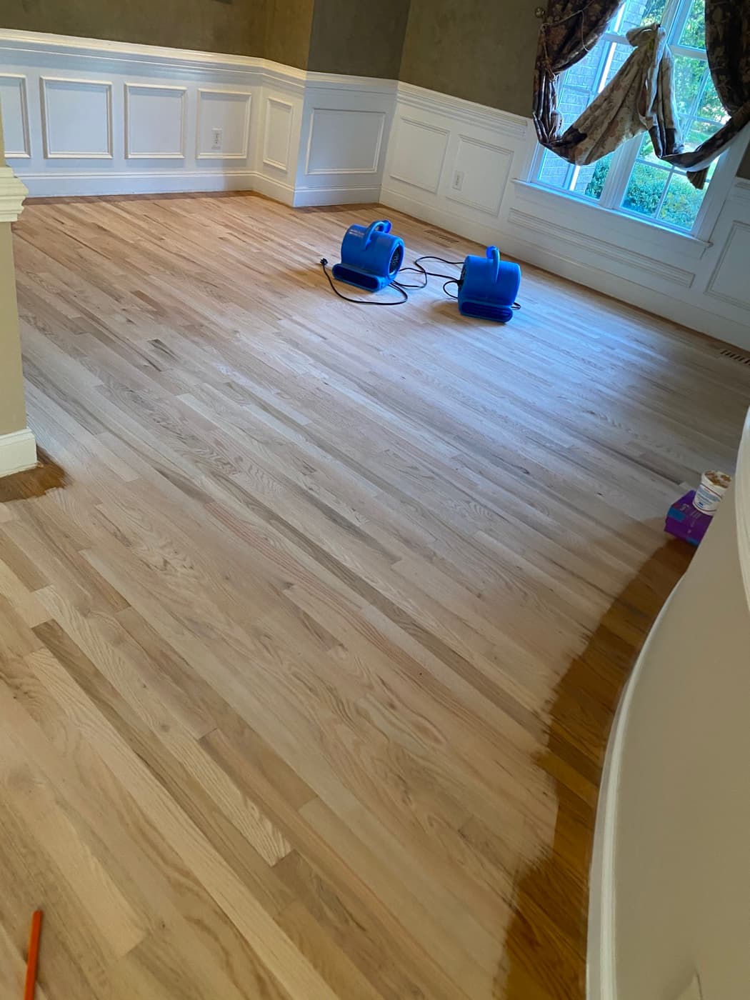 Full main level red oak floor sanded bare with two air movers running at Sunset Lakes Fuquay-Varina NC