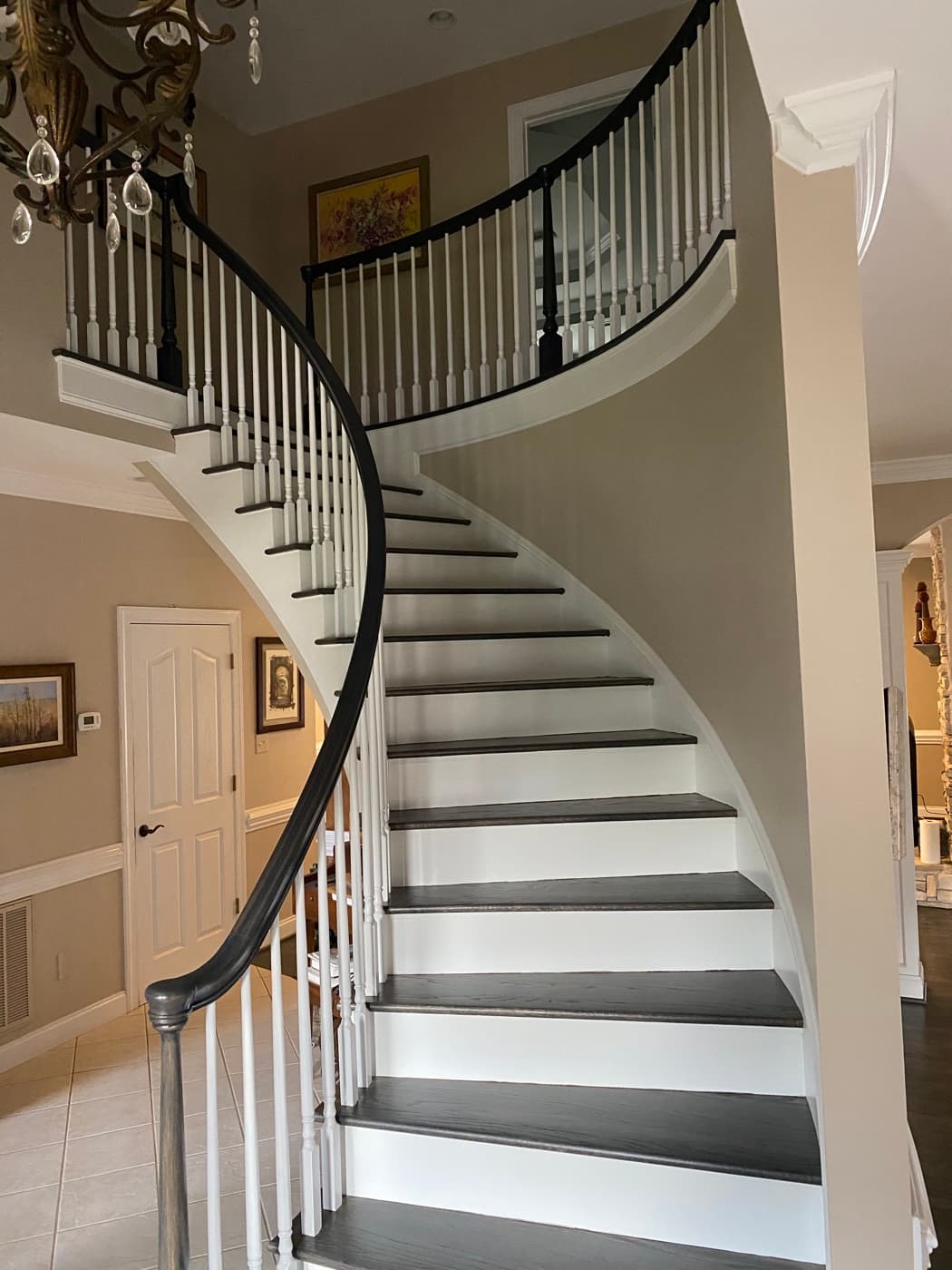 Wide view of finished curved staircase with Bona Driftwood stained treads at Sunset Lakes Fuquay-Varina NC