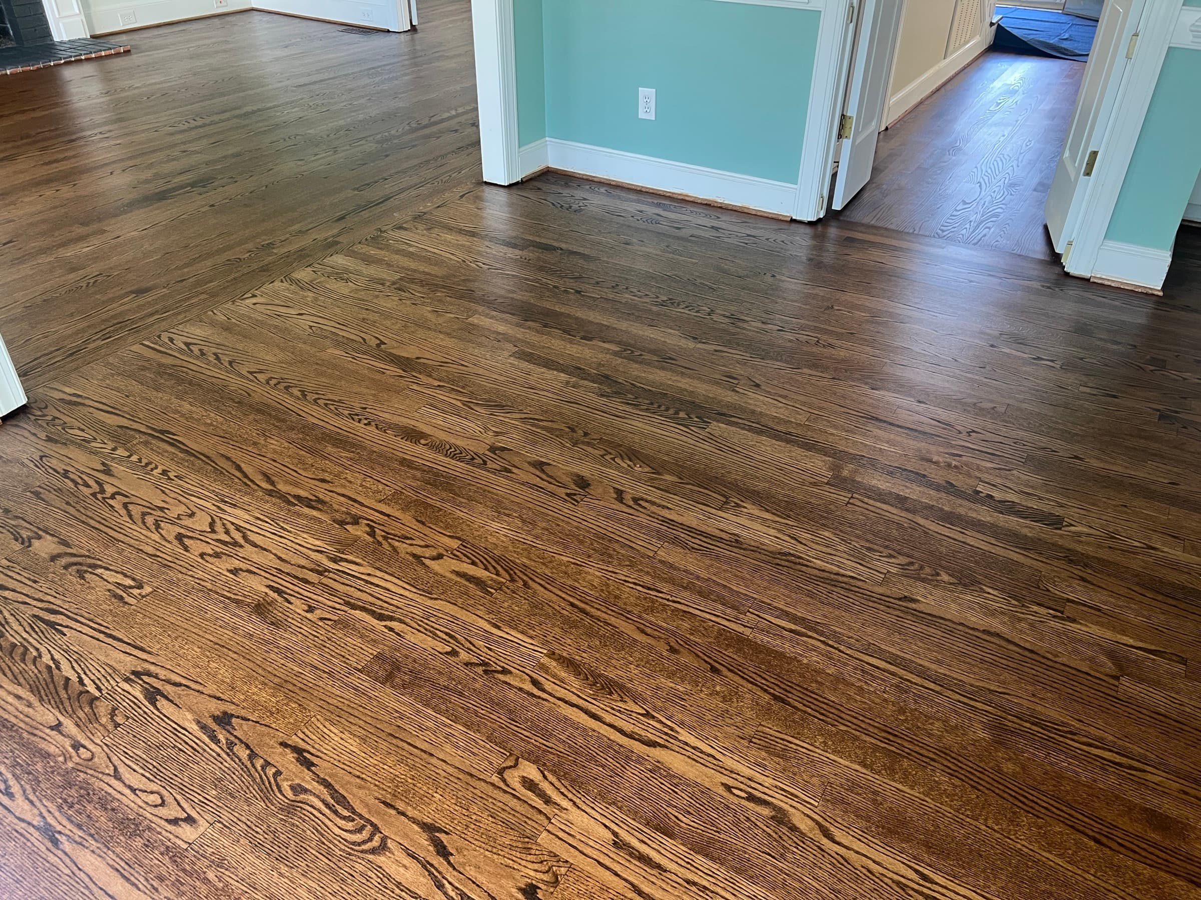 Finished red oak floors running continuous through family room and hallway in Umstead Ridge Raleigh NC, DuraSeal Medium Brown blend match