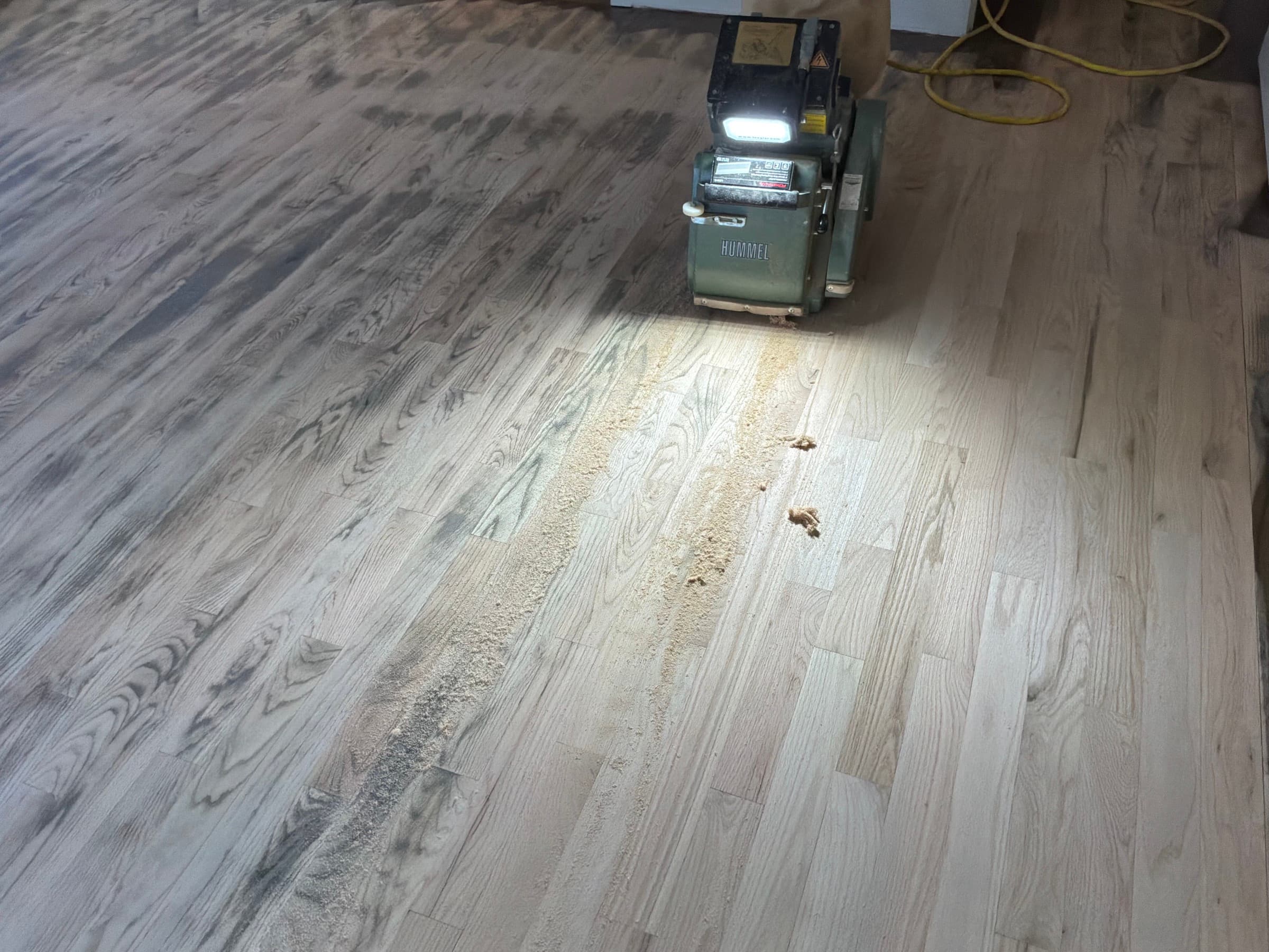 Lagler Hummel drum sander on red oak floors during blend match refinishing in Umstead Ridge Raleigh NC
