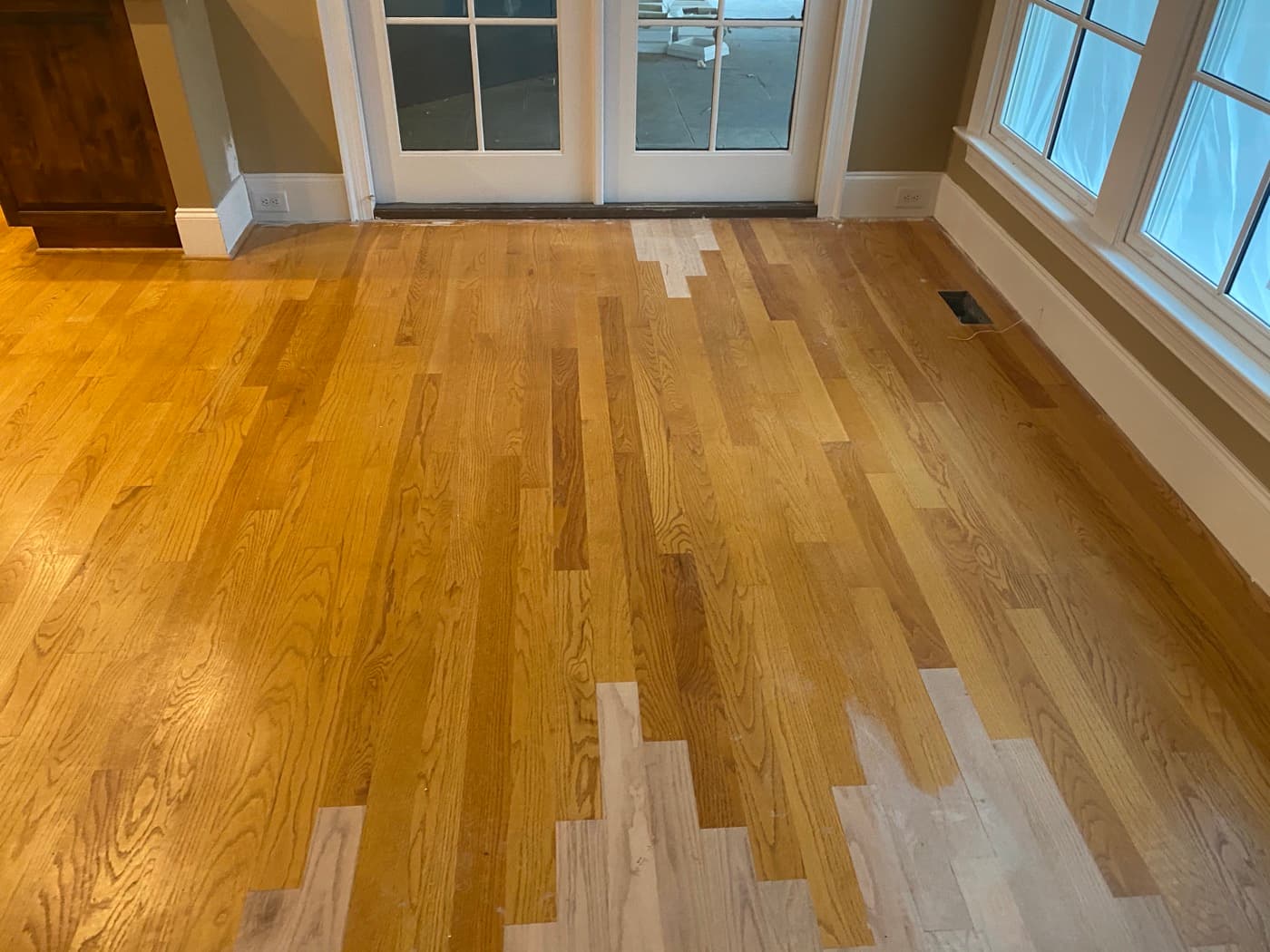 Lace-in repair boards in family room with French doors, new red oak mixed with existing in Crabtree Heights Raleigh NC