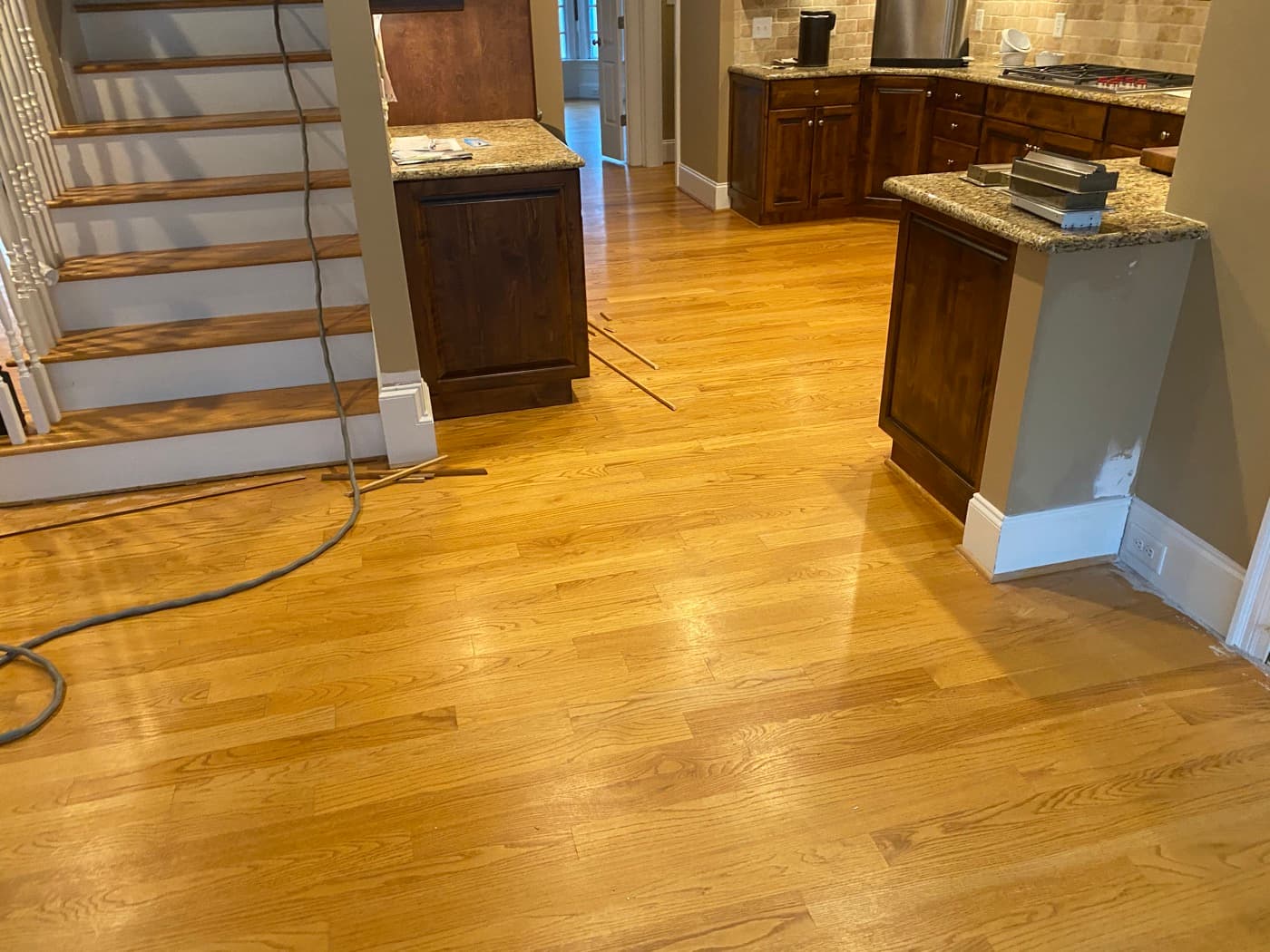 Original 3.25-inch red oak floors with heavy orange-amber cast in Crabtree Heights Raleigh NC before refinishing