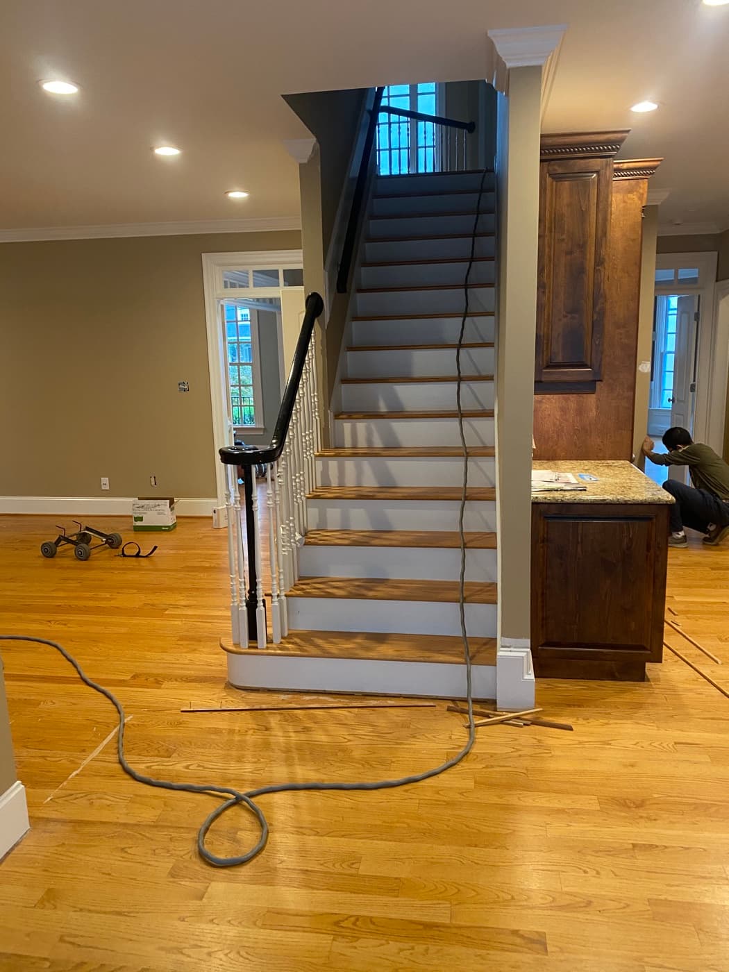 Staircase and main level overview showing original orange red oak floors in Crabtree Heights Raleigh NC