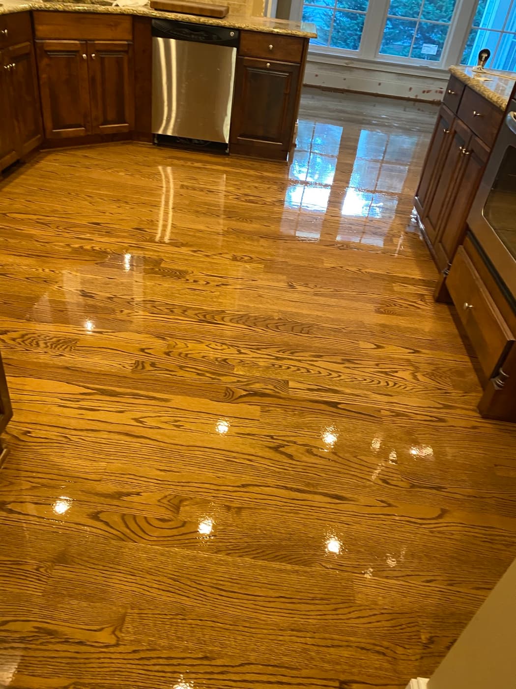 Finished 3.25-inch red oak floors with DuraSeal Special Walnut and Bona Traffic HD in kitchen at Crabtree Heights Raleigh NC