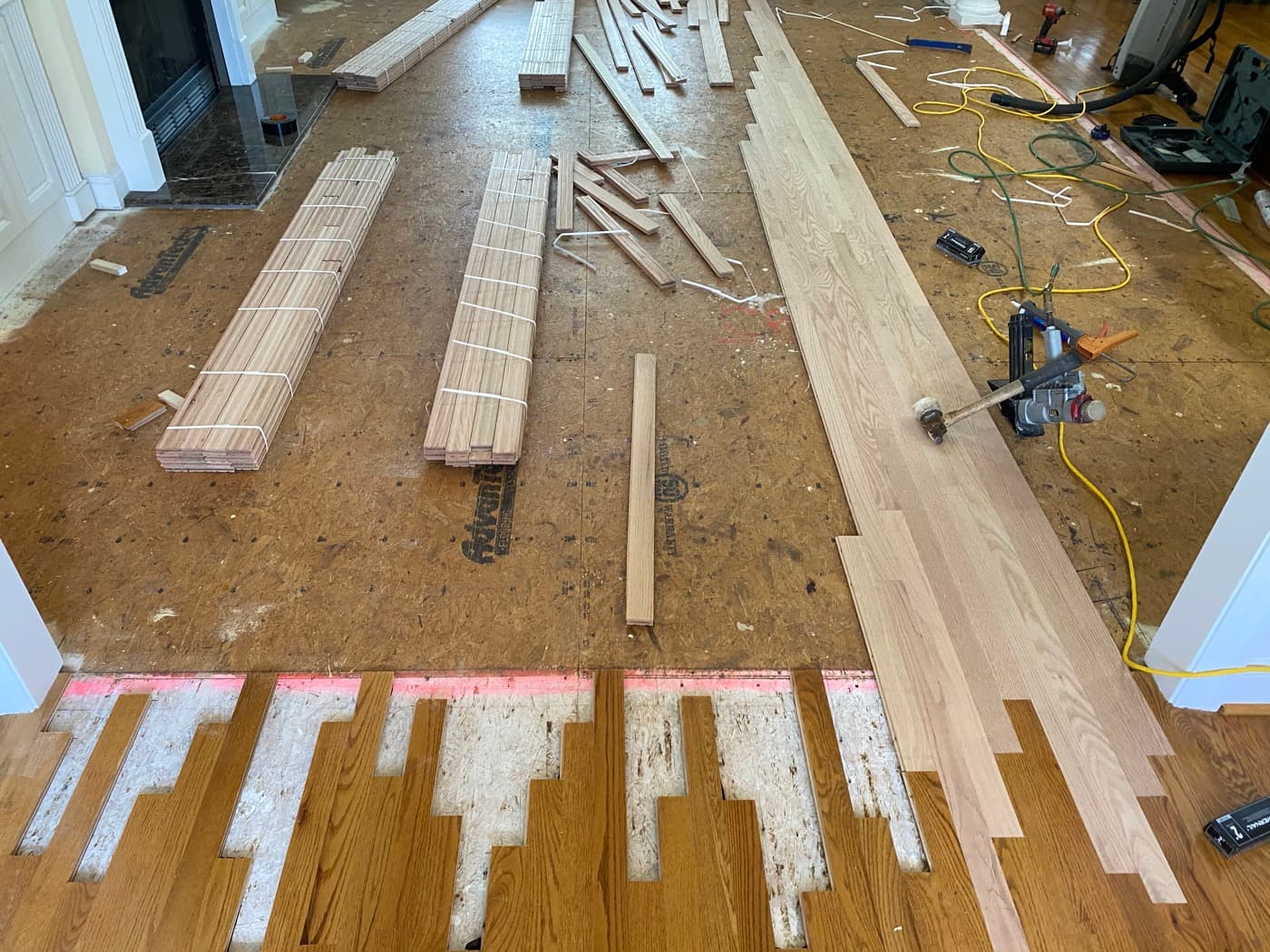 Wide view of lace-in installation progress with subfloor visible at Tanner's Creek Wendell NC
