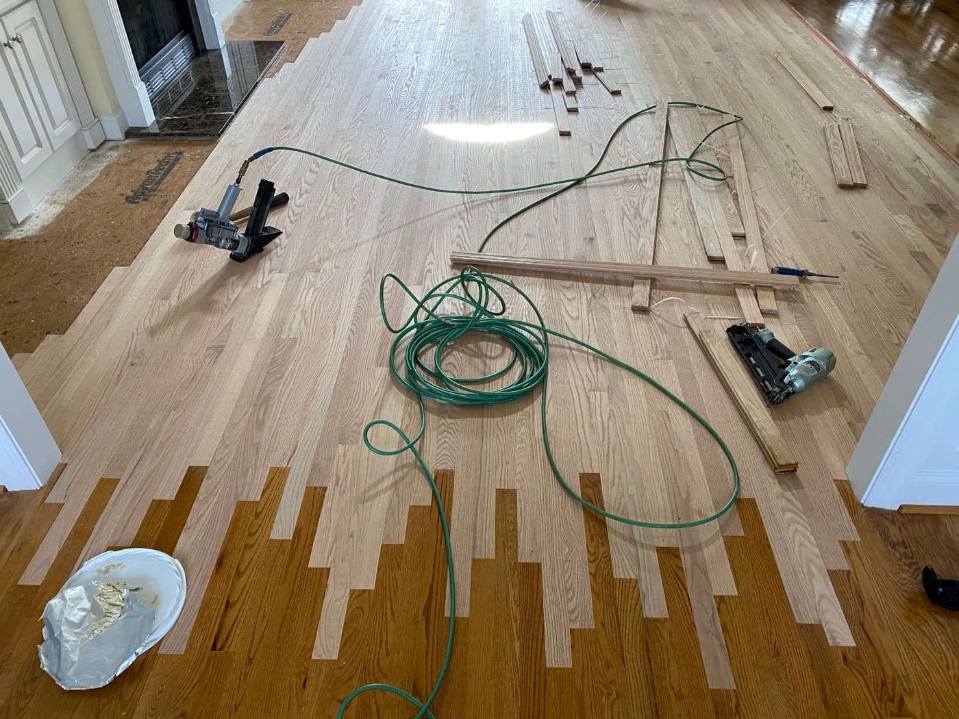 Lace-in installation nearly complete with red oak covering family room at Tanner's Creek Wendell NC