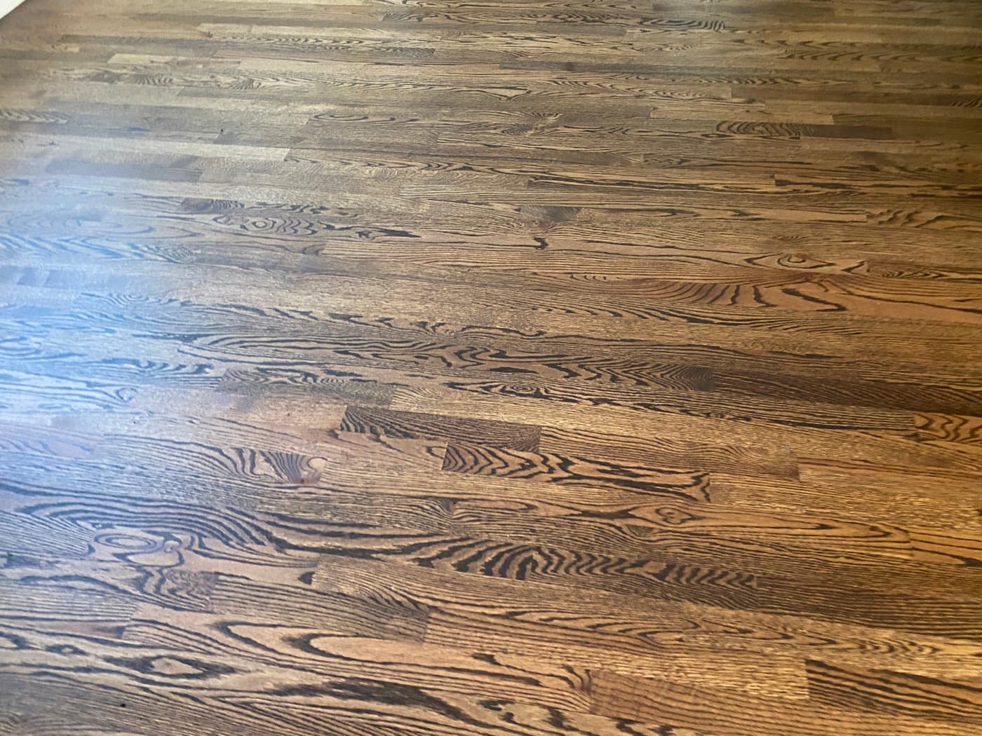 Close-up of custom Rubio Monocoat 2C dark warm brown color on red oak hardwood Tanner's Creek Wendell NC