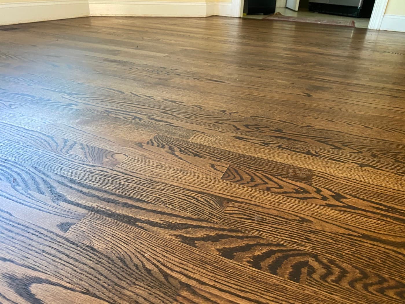 Finished red oak hardwood floors with Rubio Monocoat 2C dark color at fireplace Tanner's Creek Wendell NC