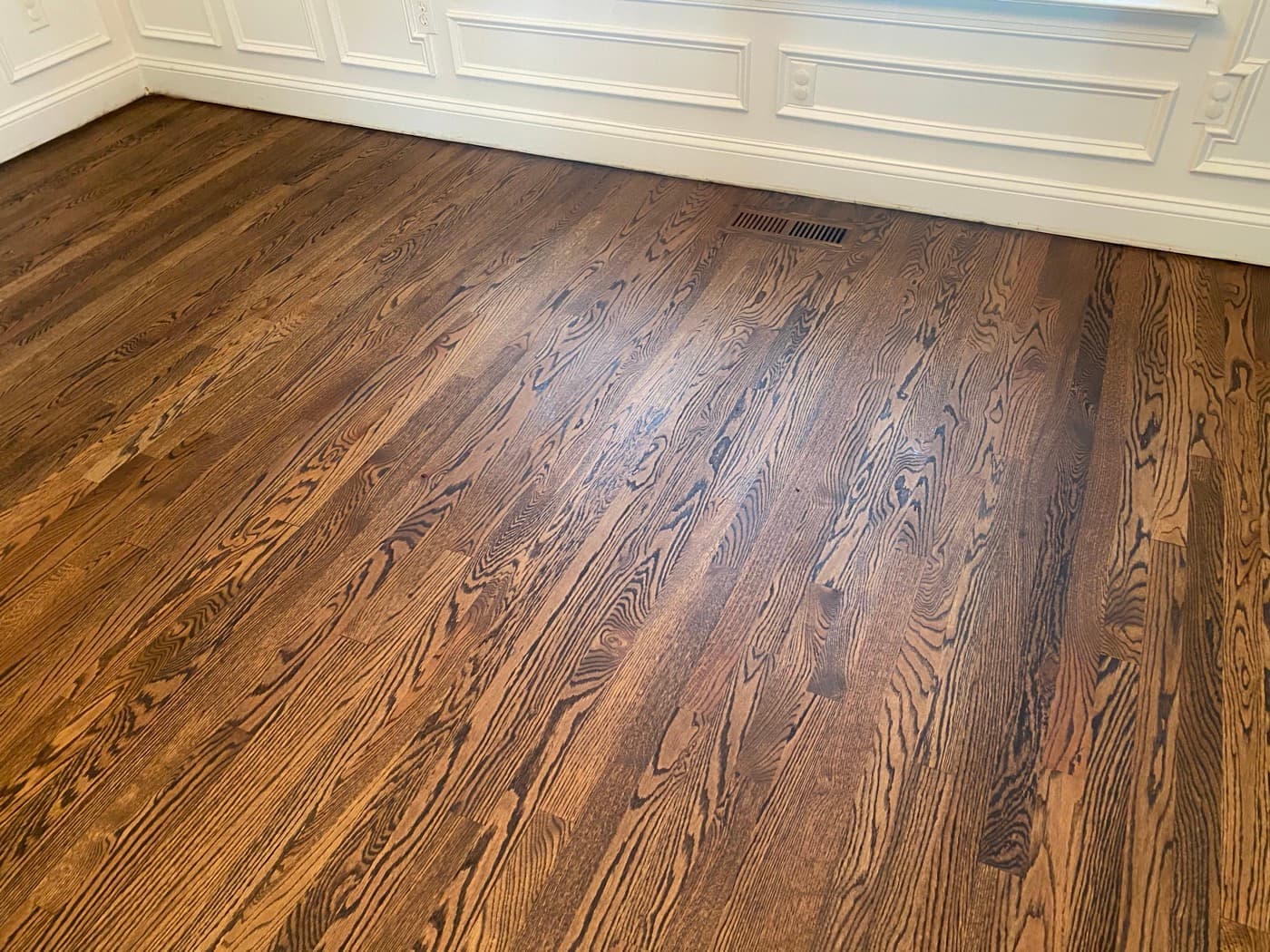 Red oak hardwood floors with custom Rubio Monocoat 2C dark color and wainscoting at Tanner's Creek Wendell NC