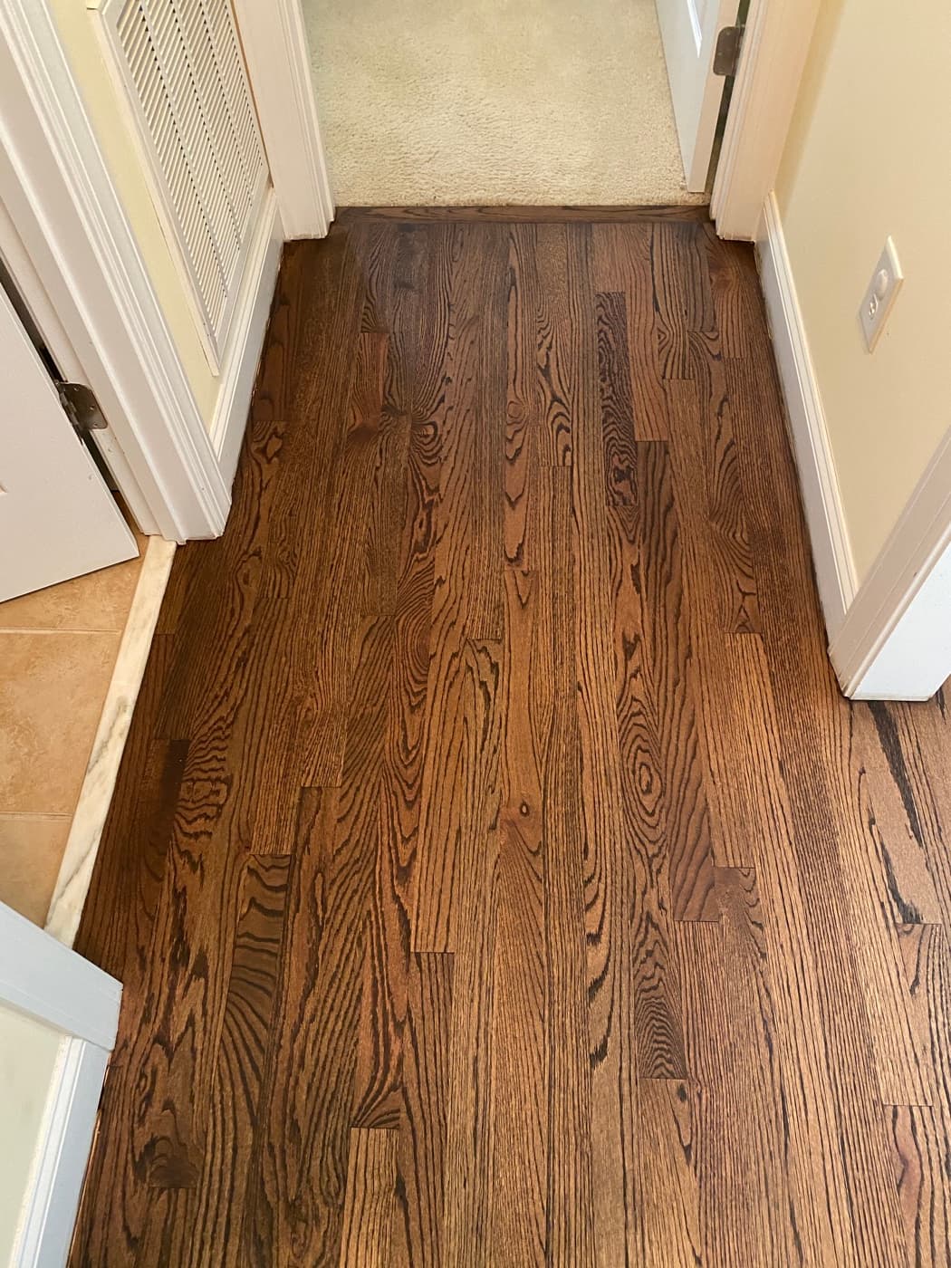 Hallway with finished red oak floors and custom Rubio Monocoat 2C dark color Tanner's Creek Wendell NC