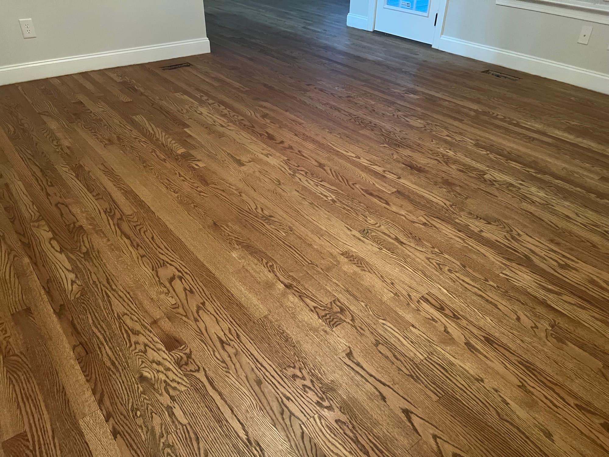 Finished red oak floors throughout family room in Summerset Place Clayton NC, custom Berger Seidle hardwax oil blend, warm brown matte finish
