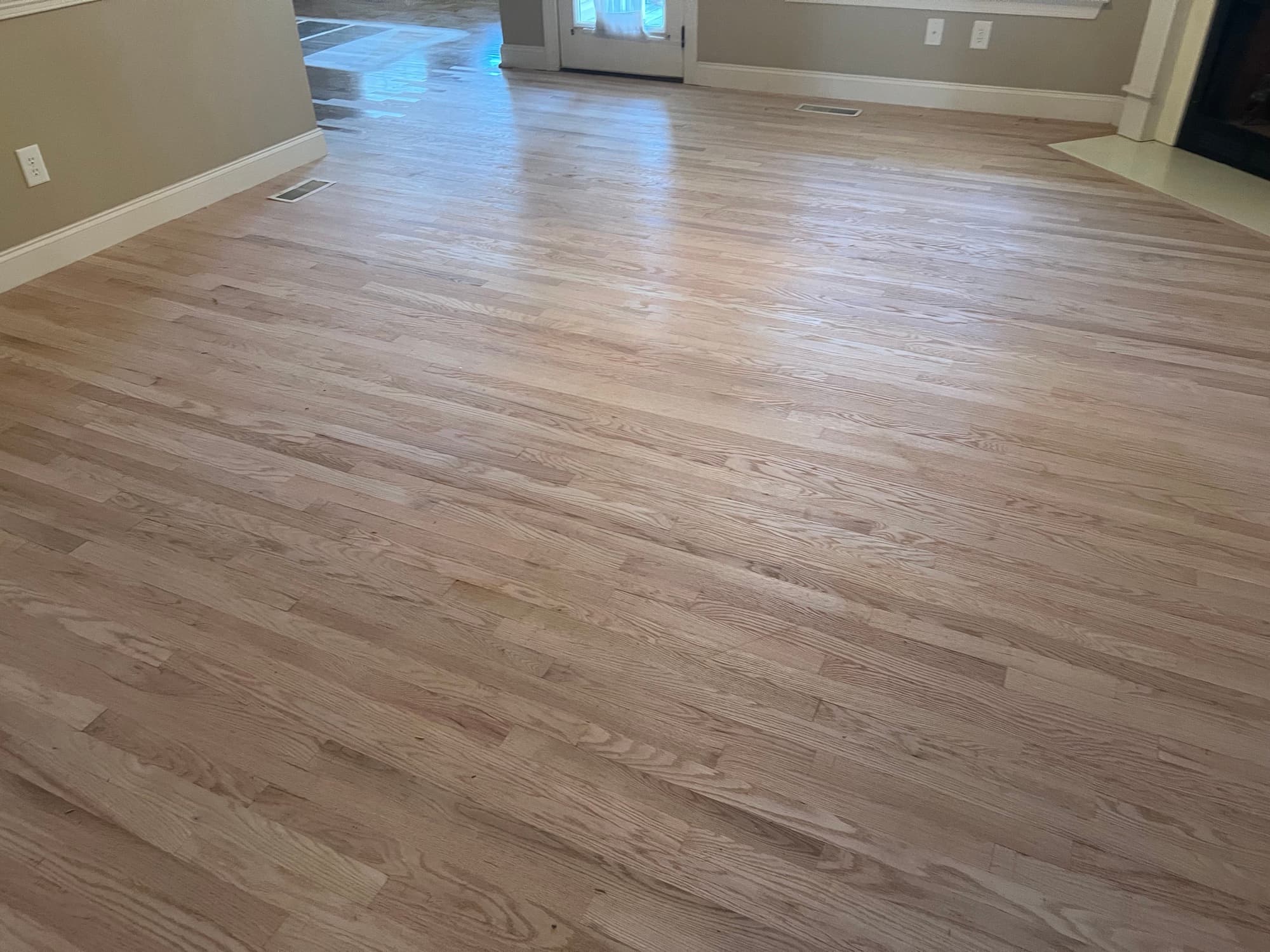 Red oak family room floor sanded bare before finish in Summerset Place Clayton NC, clean pale wood ready for Berger Seidle hardwax oil