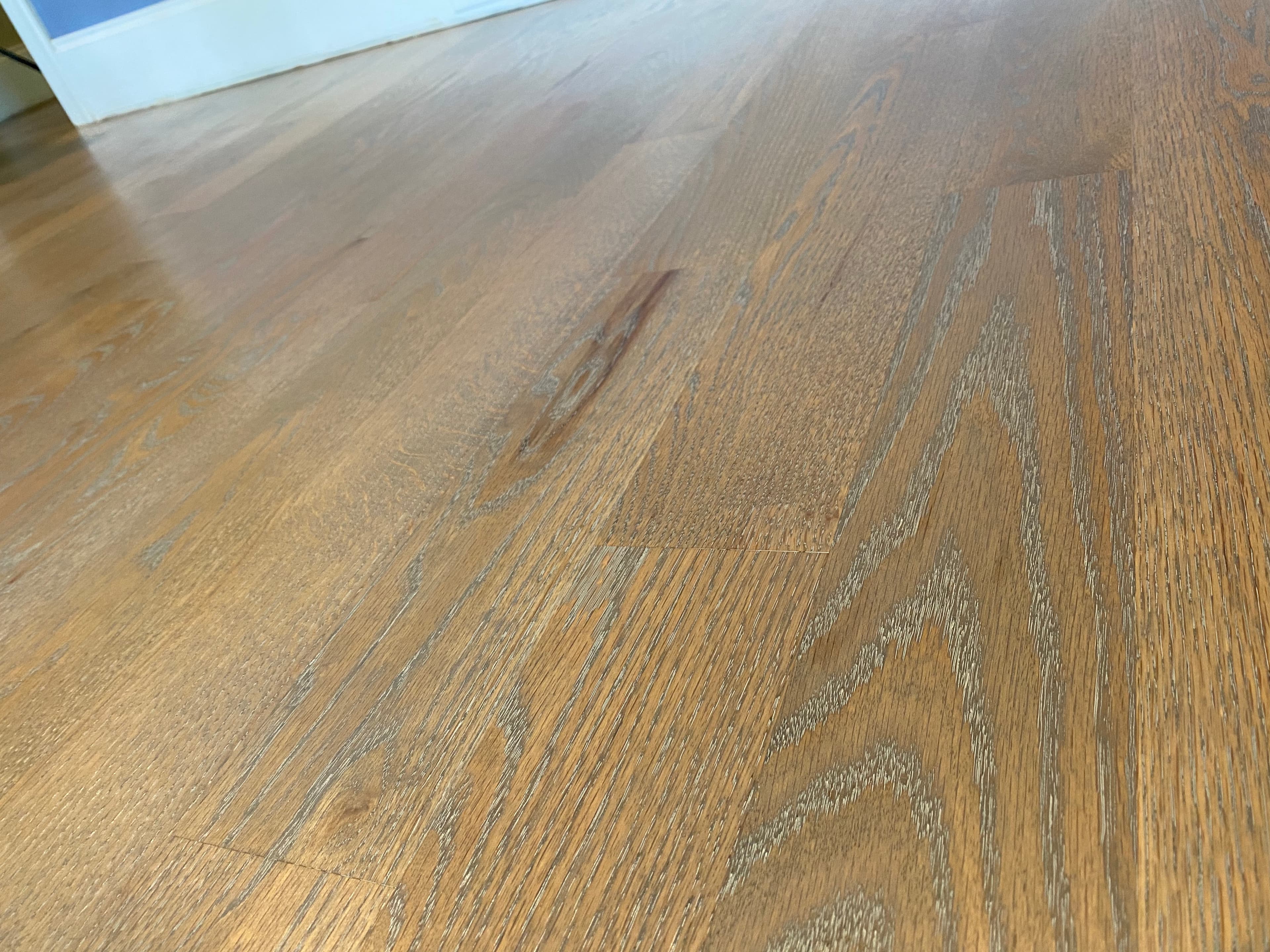 Finished 4 inch red oak floors with DuraSeal Aged Barrel and Rubio Monocoat 5% White Oil ceruse in Turner Downs Raleigh NC, two-toned grain contrast