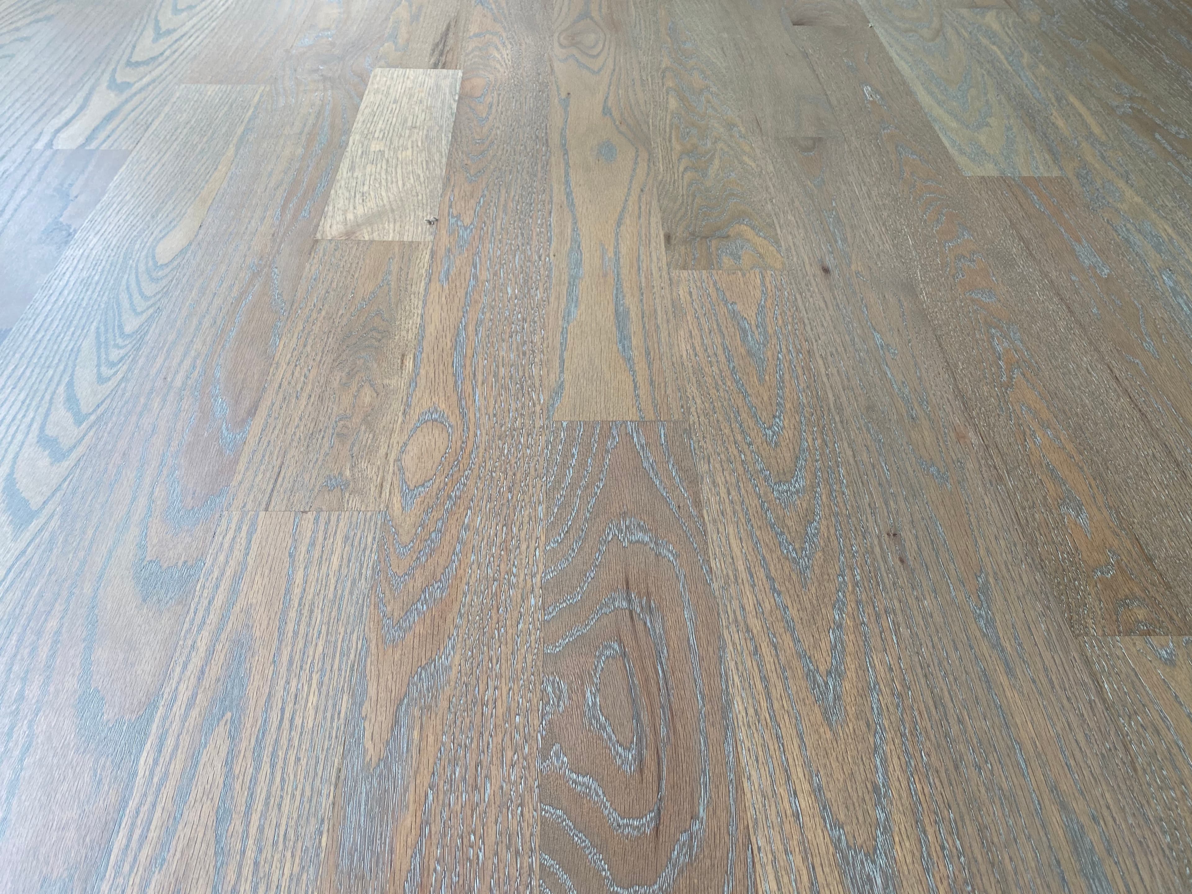 Cerused red oak floor detail in Turner Downs Raleigh NC, white grain channels against aged barrel brown from Rubio Monocoat white oil over DuraSeal stain