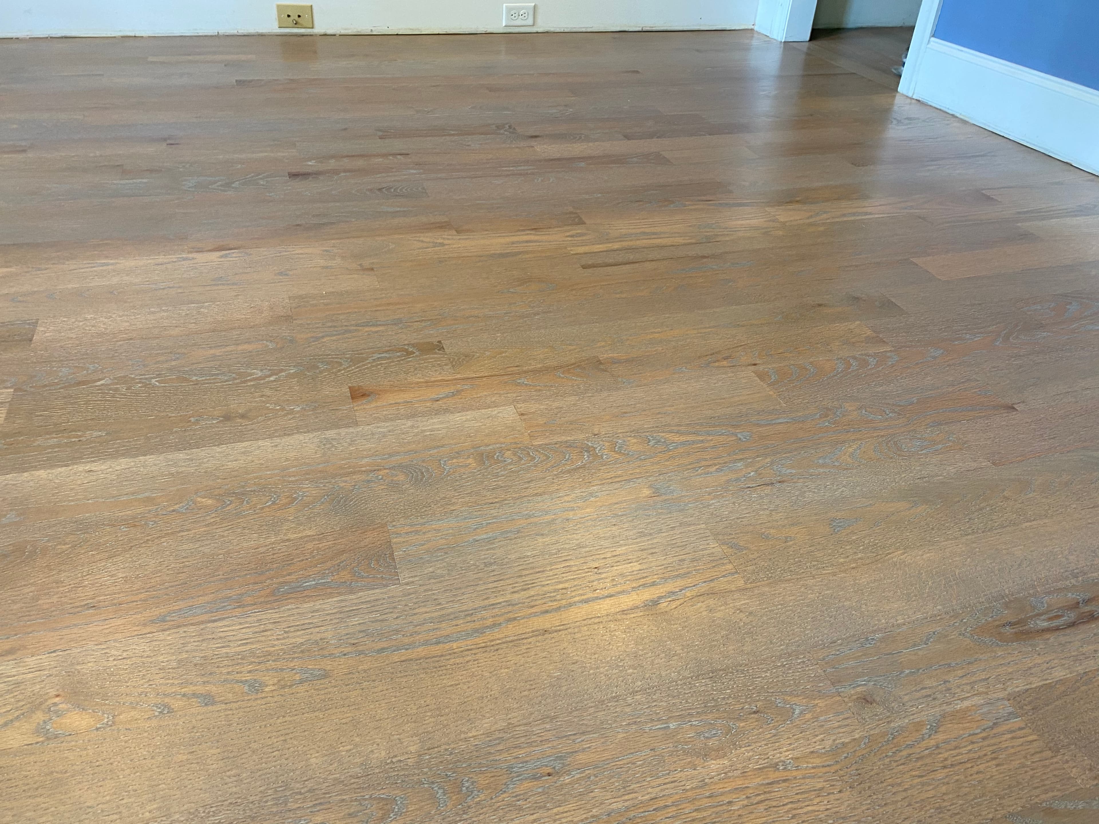 Finished red oak floors with Rubio Monocoat white oil ceruse in Turner Downs Raleigh NC, cool two-toned effect across full room
