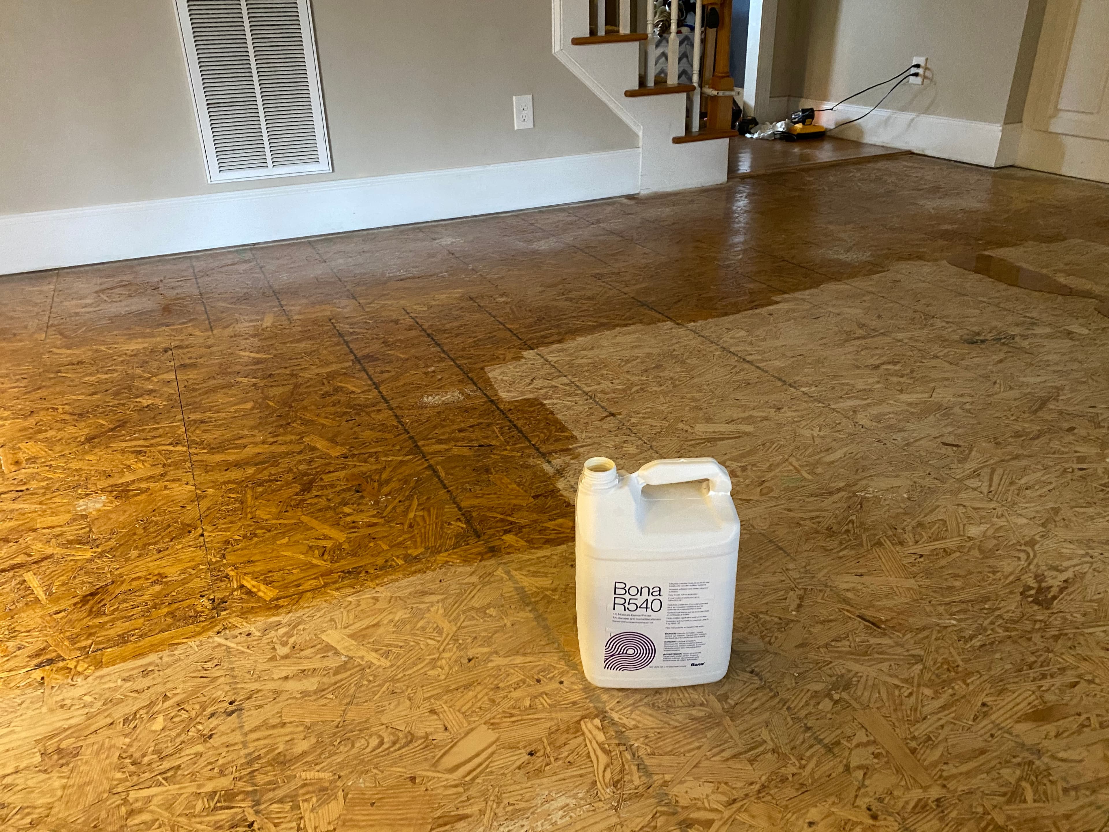 Bona R540 moisture barrier rolled onto subfloor before red oak installation in Turner Downs Raleigh NC