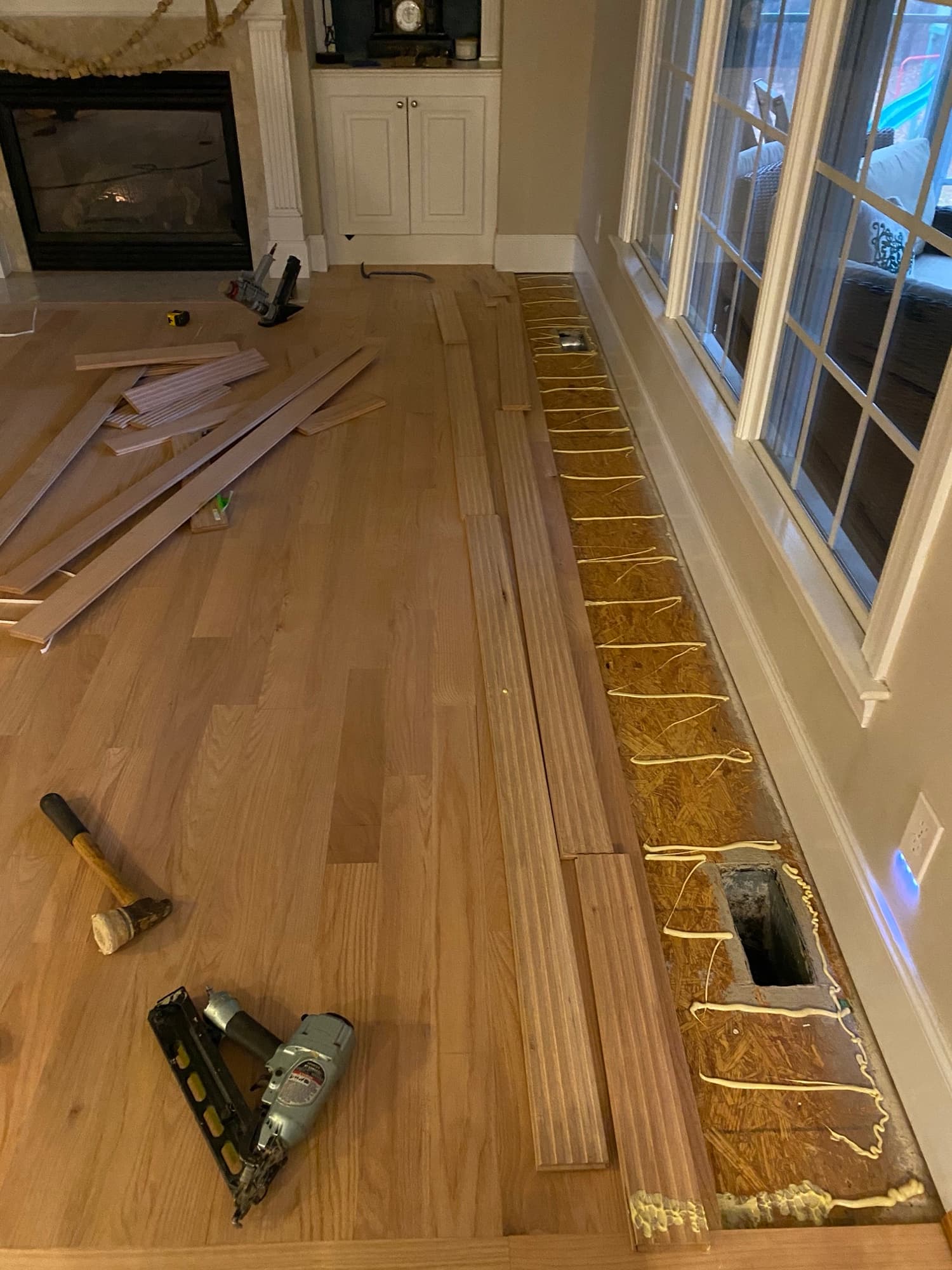 Glue and nail red oak installation in Turner Downs Raleigh NC, adhesive spread with Primatech nailer
