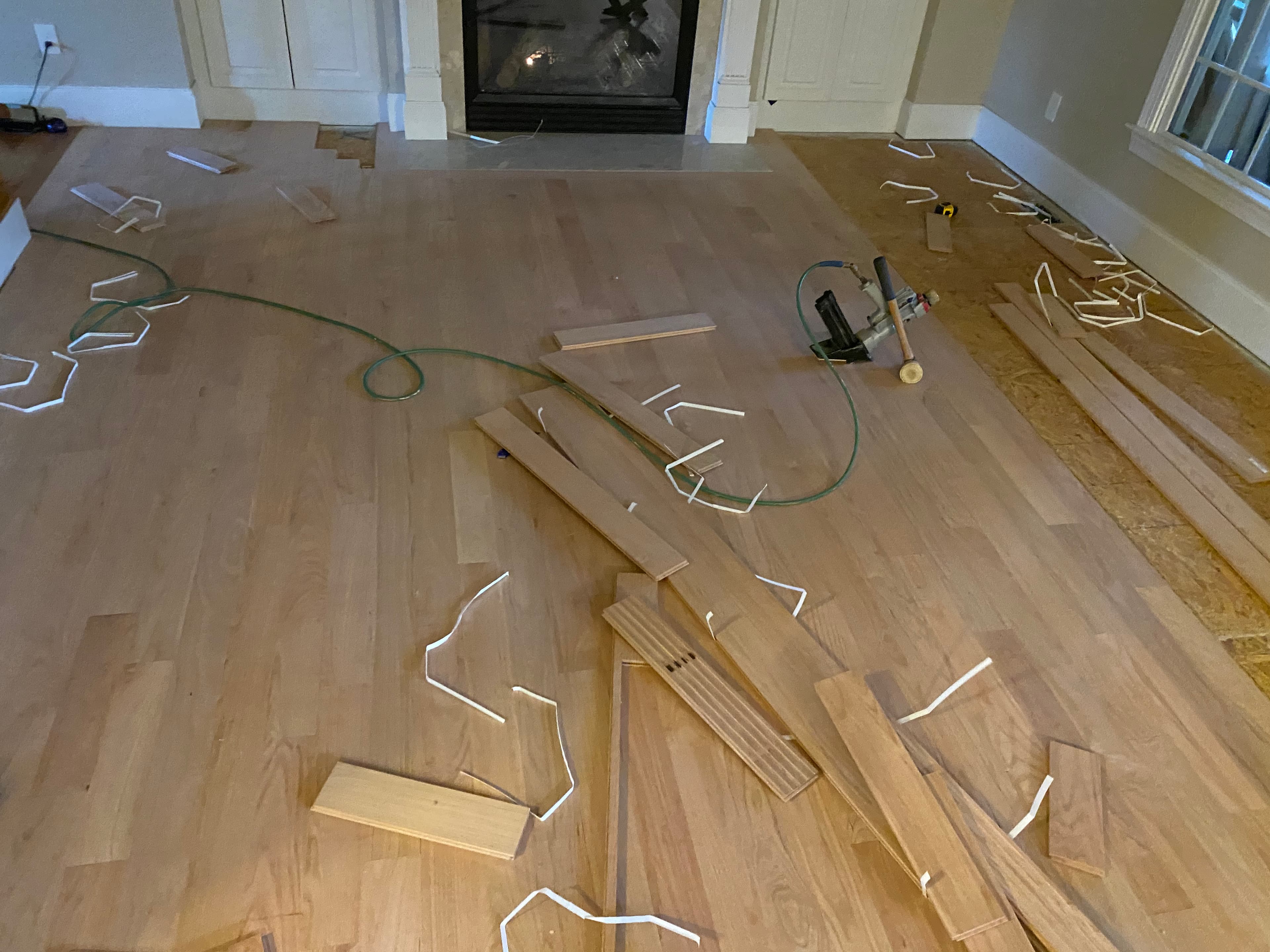 4 inch red oak installation in progress in Turner Downs Raleigh NC, nailer and cleat clips visible on new floor