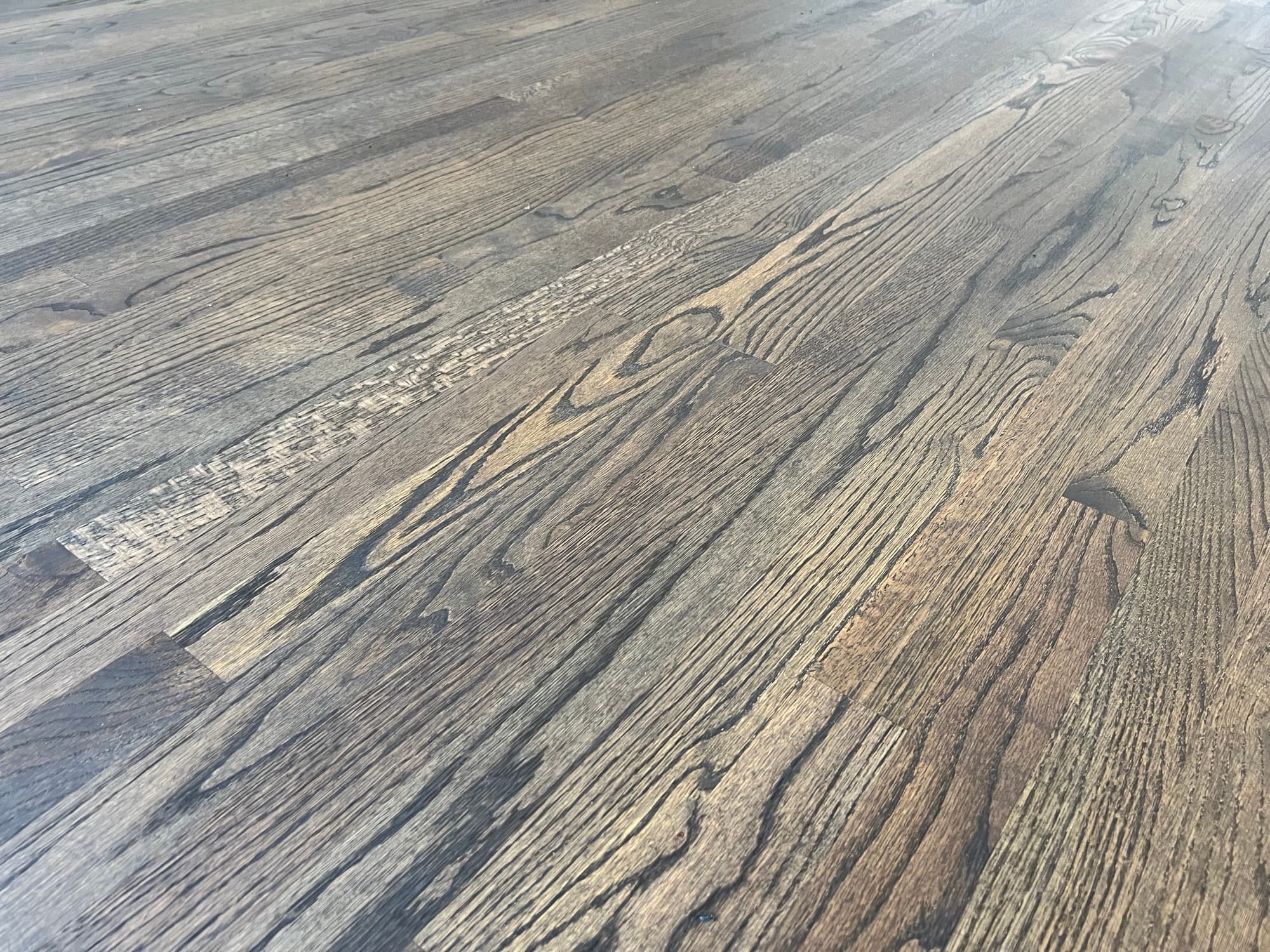 Refinished red oak floor with inlay star medallion in Austin Pond Clayton NC, custom hardwax oil blend bringing out dramatic species contrast in geometric pattern
