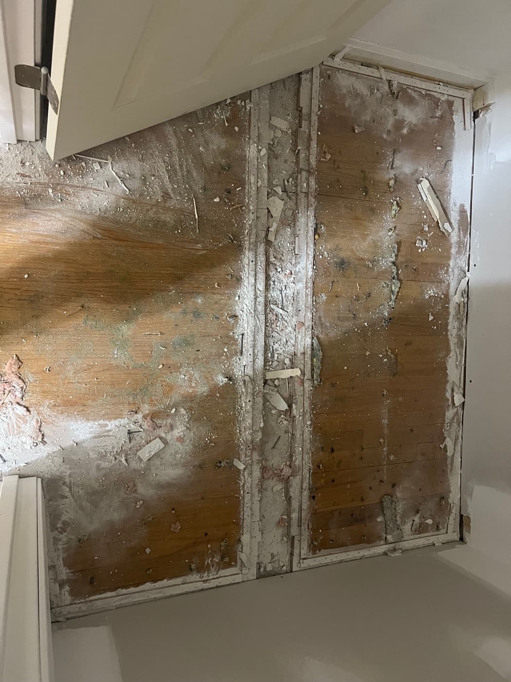 Damaged closet floor with debris and deteriorated wood before repair in Downtown Knightdale NC