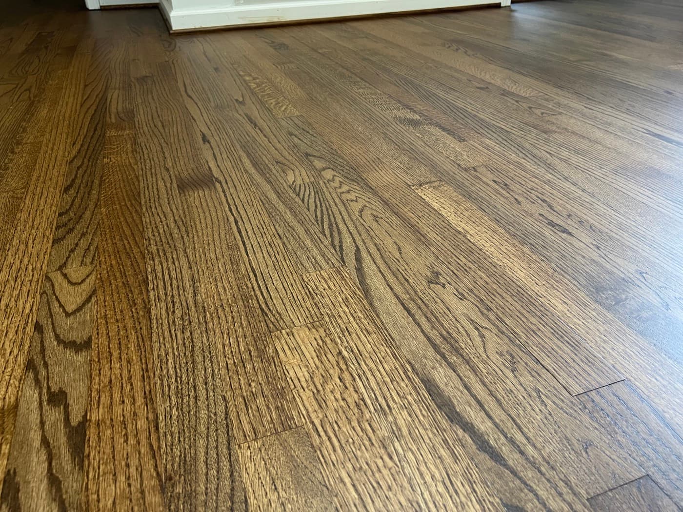 Close-up of finished red oak grain with DuraSeal Provincial stain showing wood character in Downtown Knightdale NC