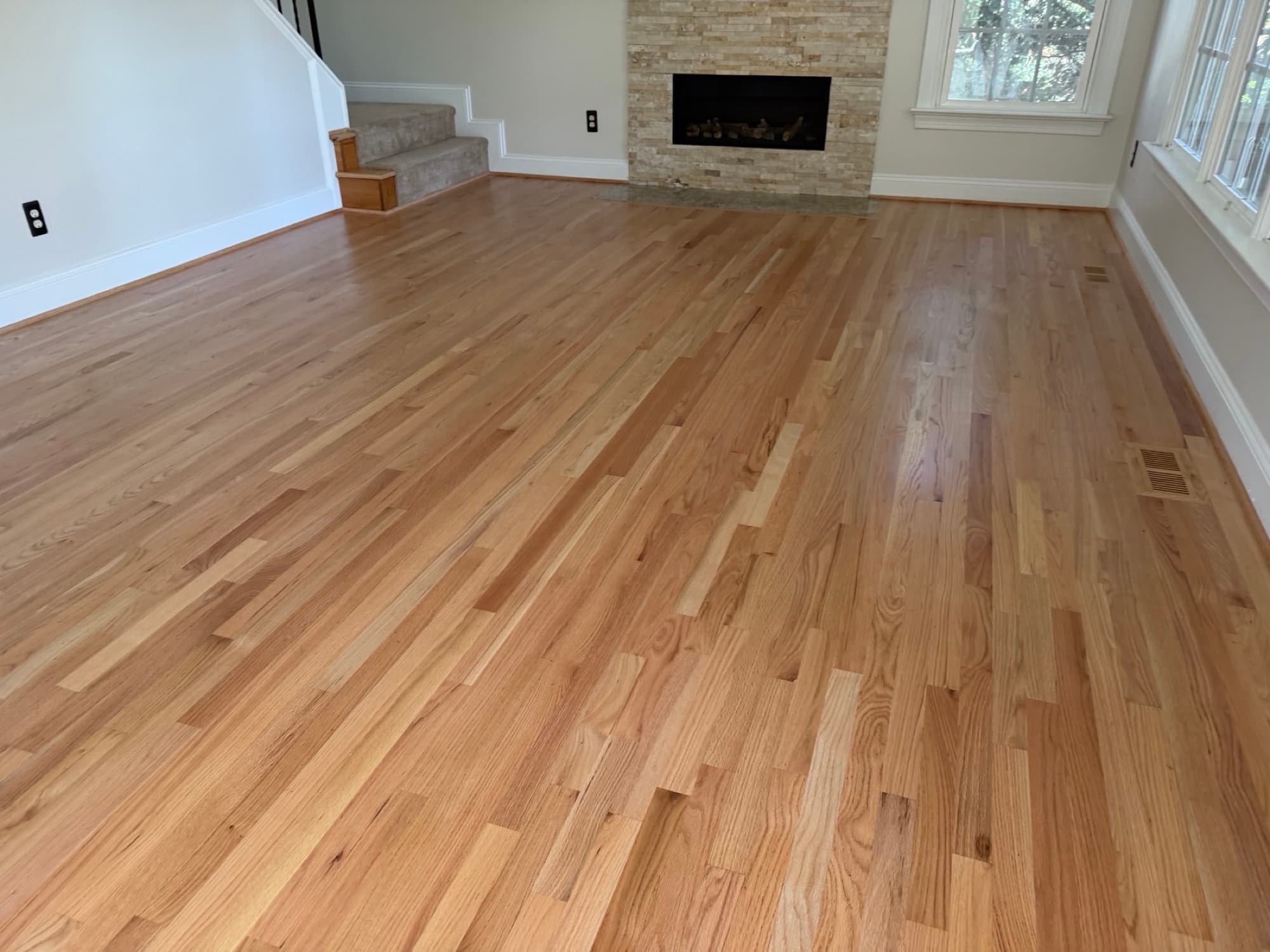 Finished 2.25 inch red oak hardwood floors in Glen Laurel Clayton NC, Bona Mega One natural satin, fireplace view