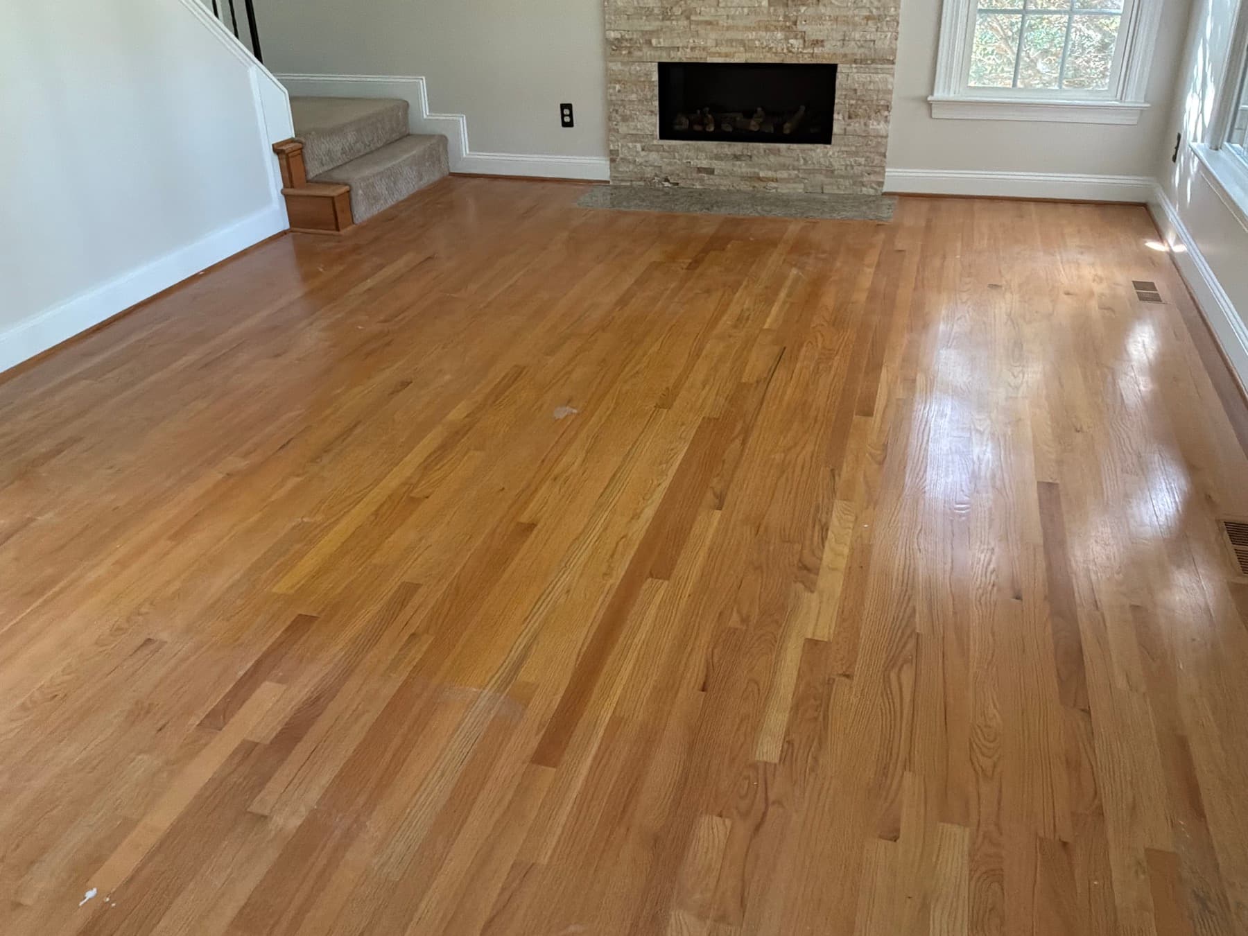 Red oak floors before refinishing in Glen Laurel Clayton NC, heavy amber and orange cast from aged oil-based polyurethane