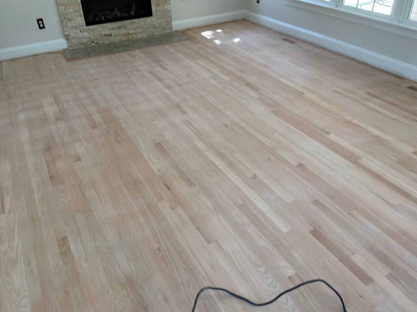 Red oak floors sanded bare in Glen Laurel Clayton NC living room ready for water-based finish
