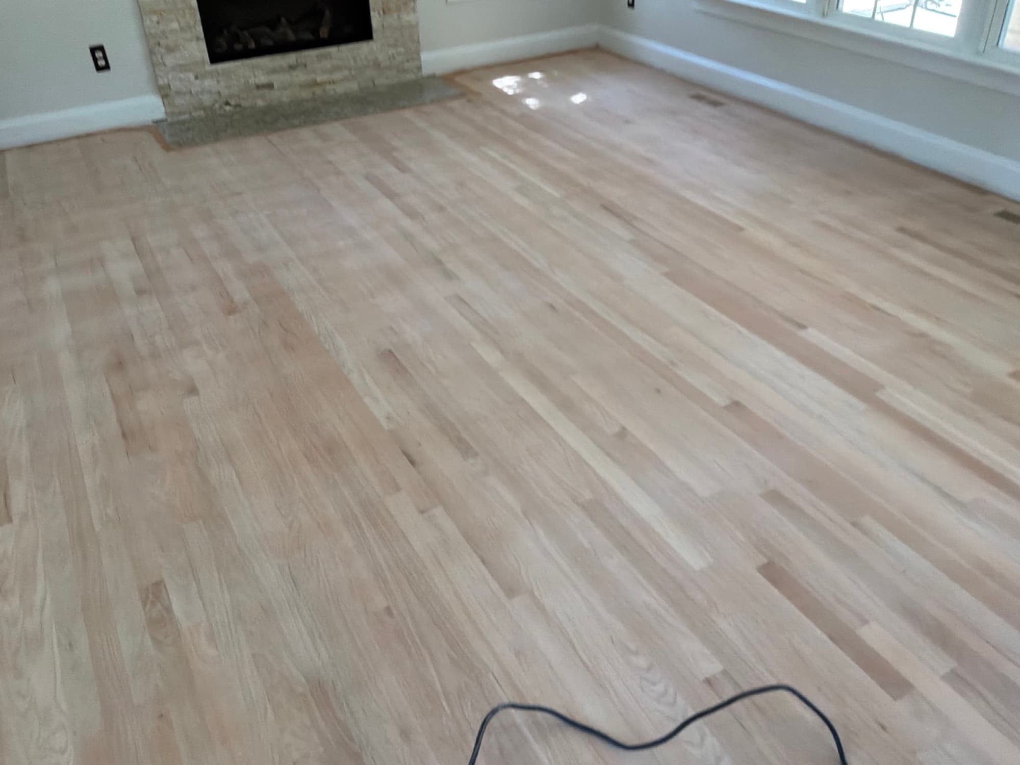 Red oak floors sanded bare in Glen Laurel Clayton NC living room ready for water-based finish