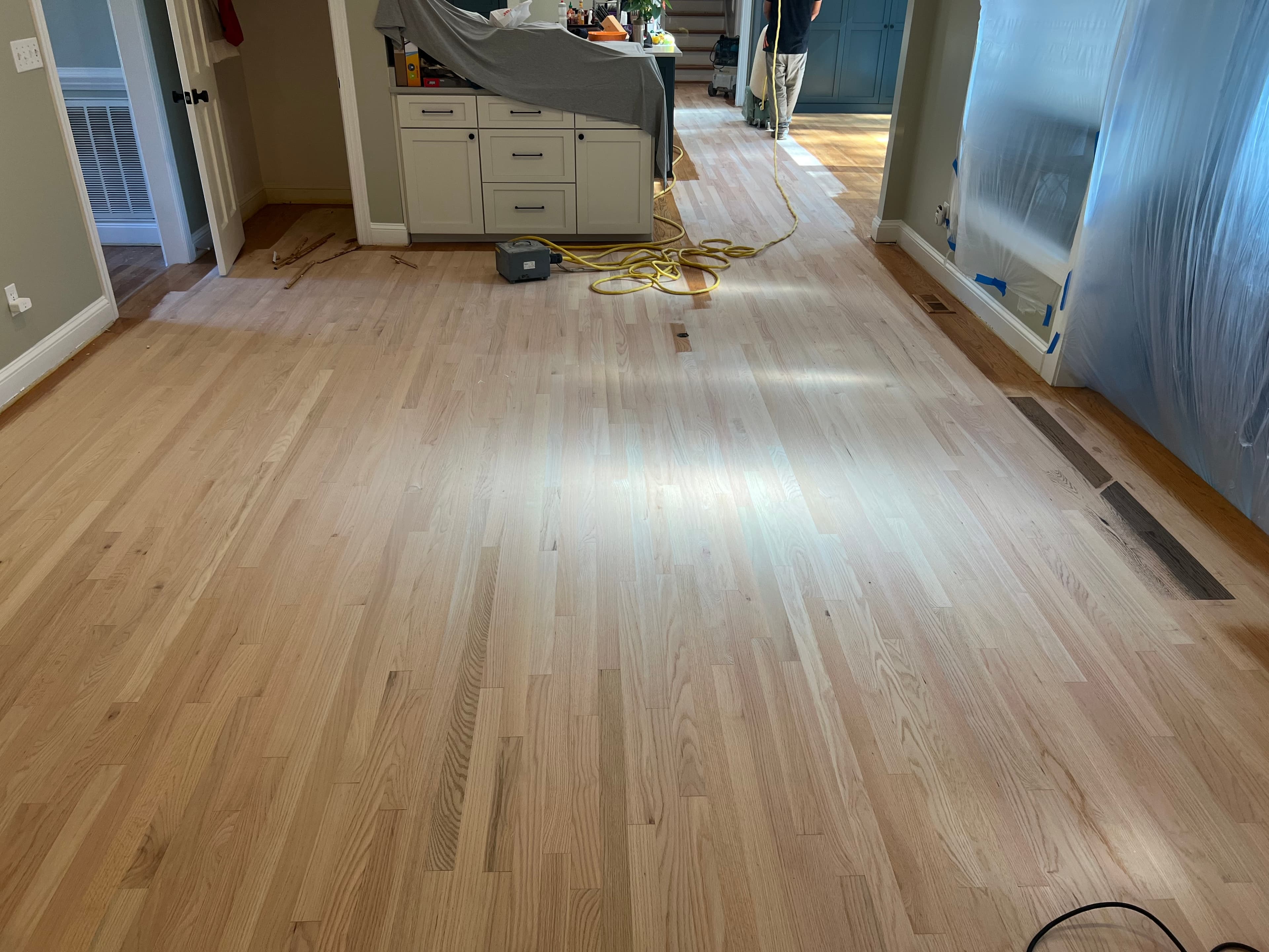 Red oak floors fully sanded to bare wood in Lochmere Cary NC, clean pale surface throughout open plan living and kitchen area