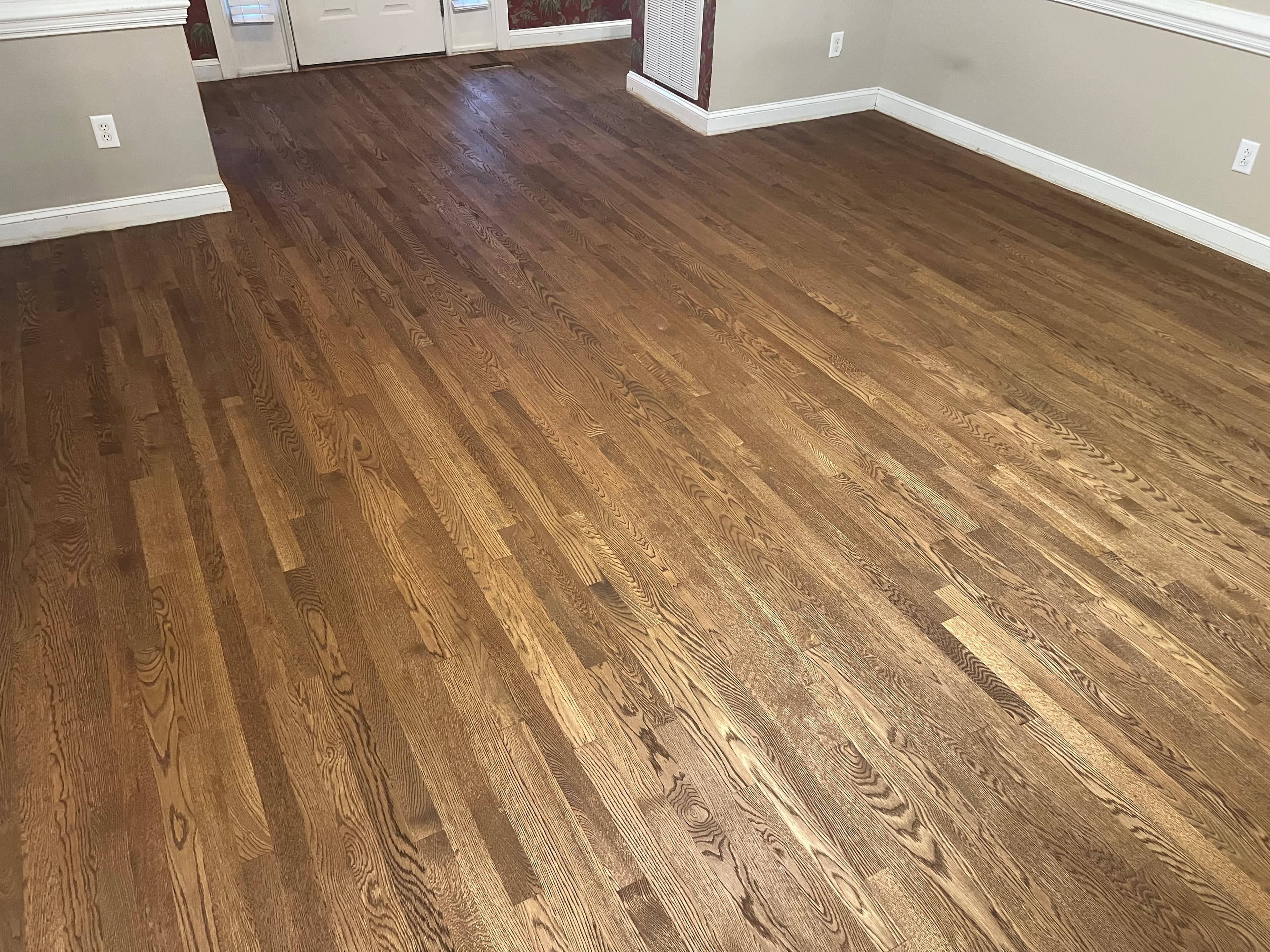 Finished red oak floors with DuraSeal Provincial stain and Bona Traffic HD in The Village Country Club Wilson NC, warm rich brown throughout living room