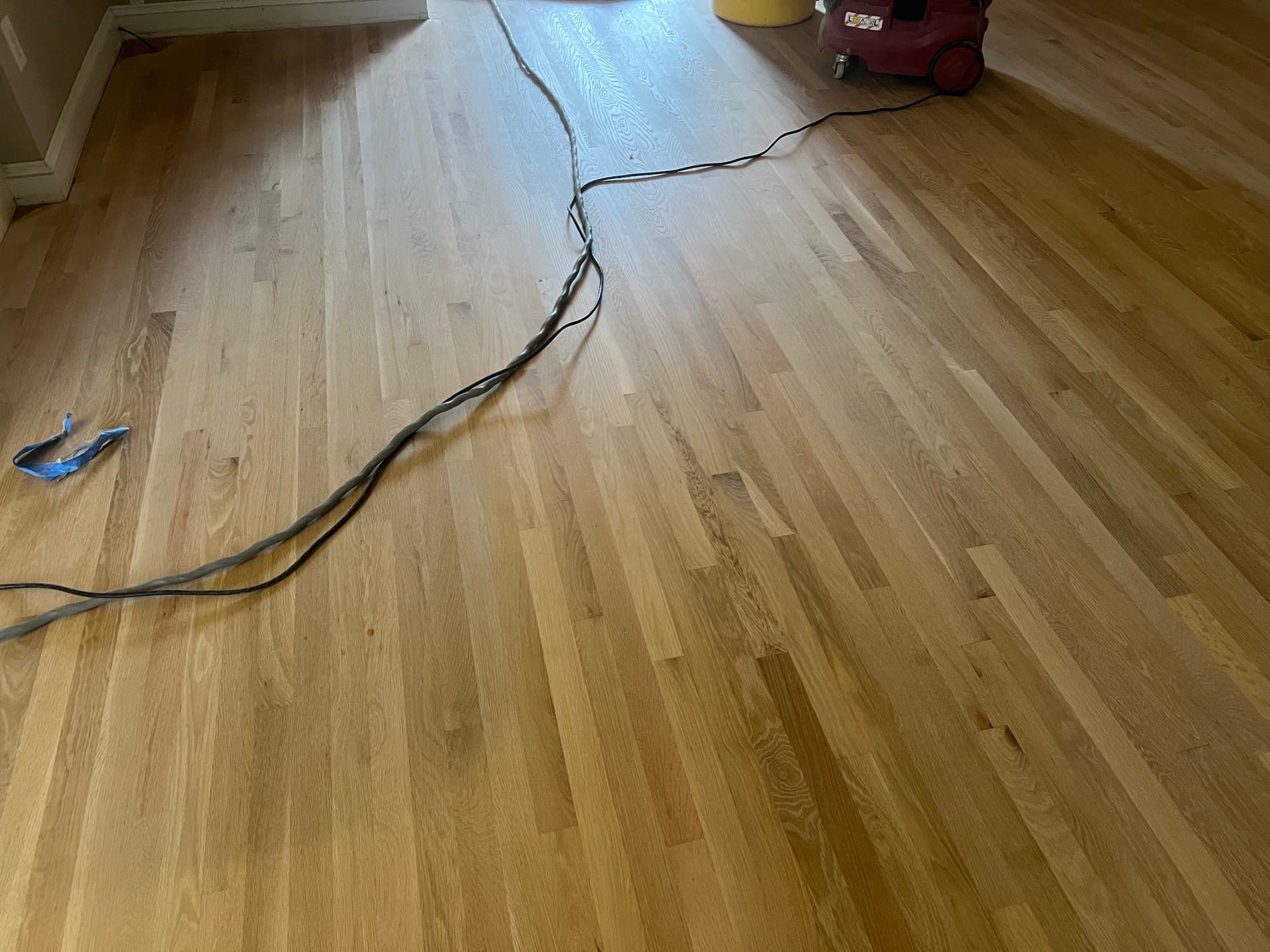 Bare sanded red oak floor close-up in Wilson NC, clean pale grain ready for DuraSeal Provincial stain