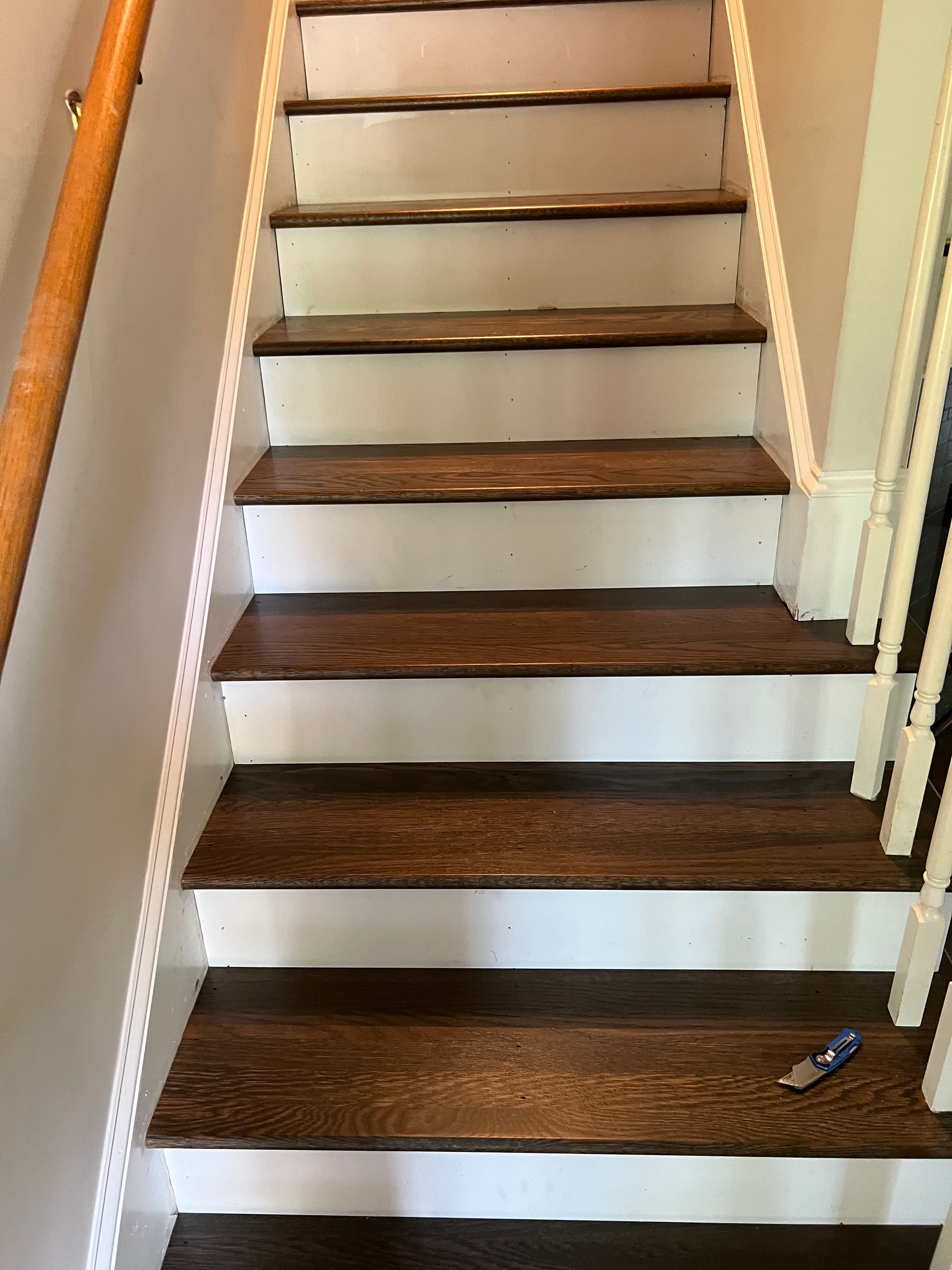 New white oak stair treads installed and stained in North Fort Clayton NC, custom blend stain applied, white painted risers, looking up staircase