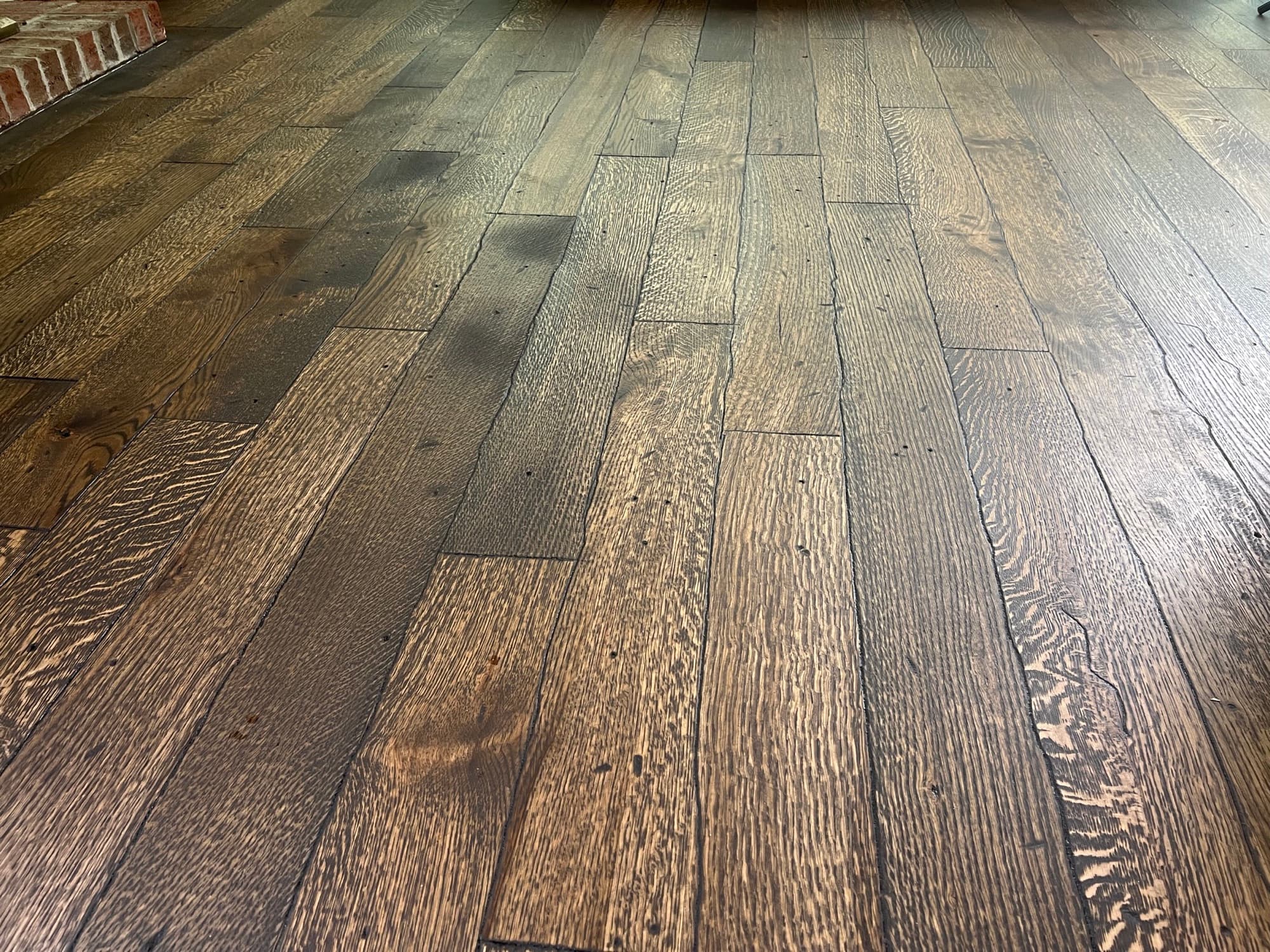 Distressed rift and quartered white oak floors with custom hardwax oil finish in Westlake Wendell NC, wire brushed and hand scraped
