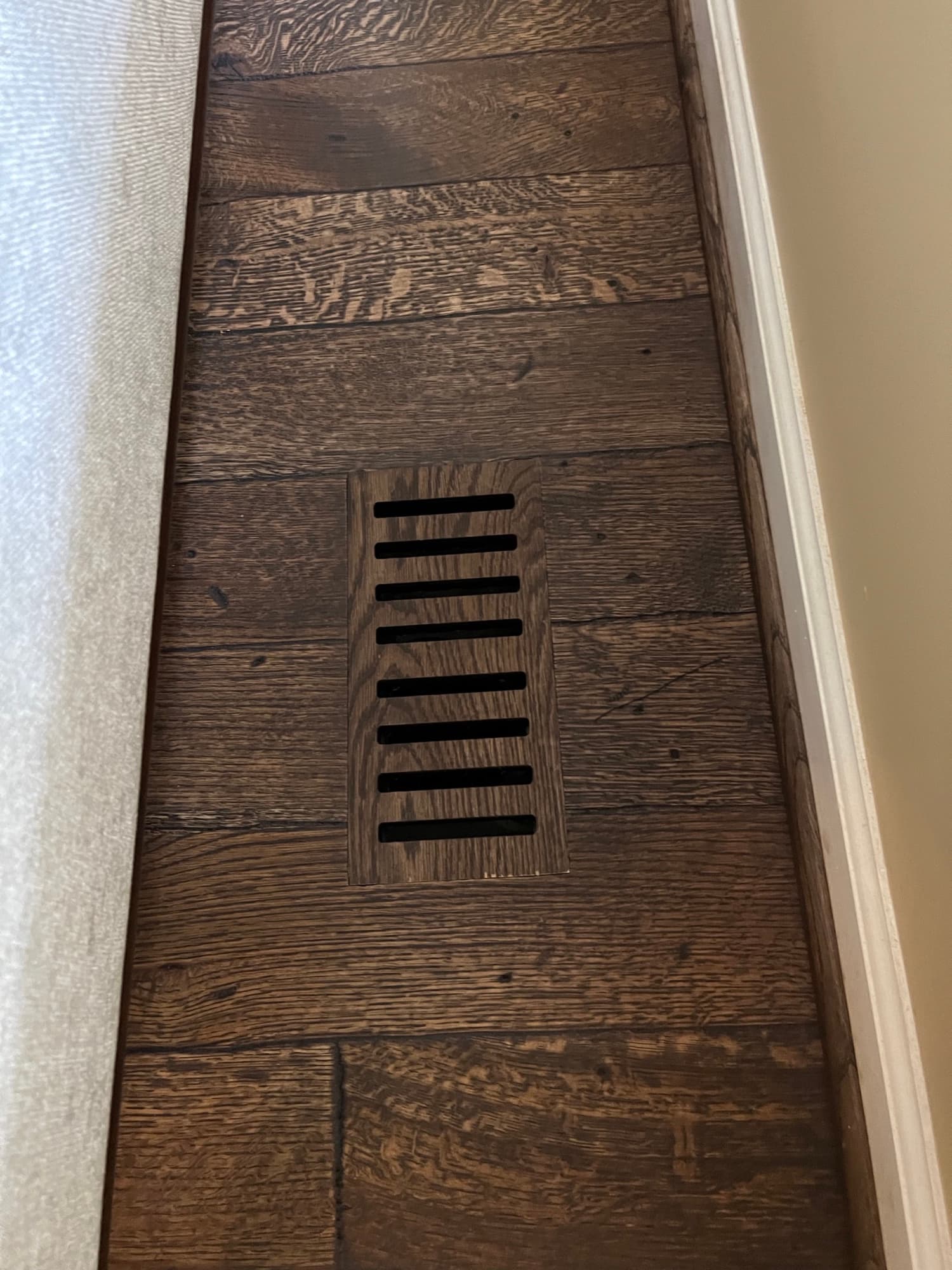 Custom flush mount hardwood floor vent in distressed white oak matching installed floor in Wendell NC Westlake