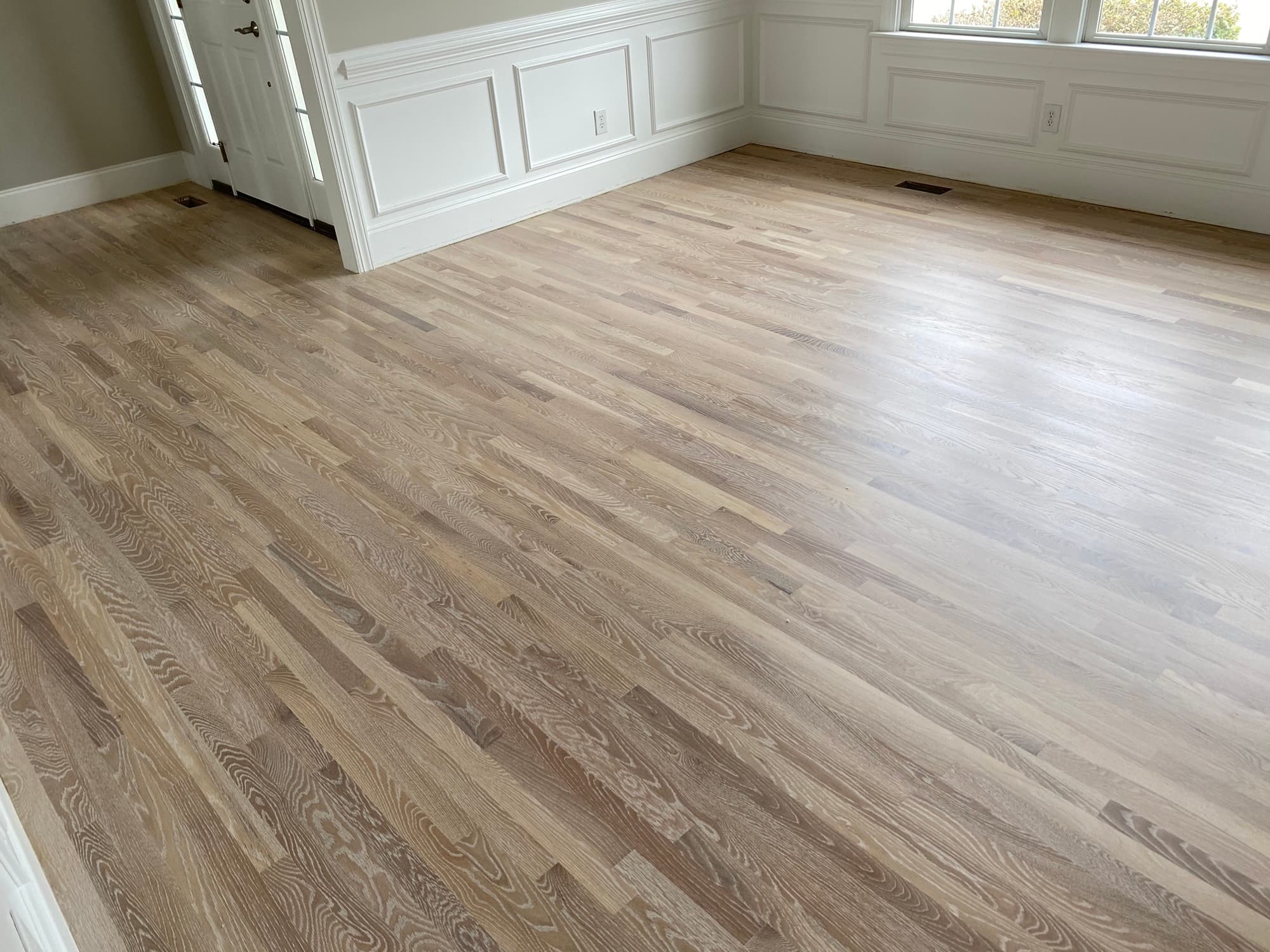 Refinished 2.25 inch white oak floors with Bona Craft Oil Frost in Heritage neighborhood Wake Forest NC, light natural finish replacing dated orange ambered floor