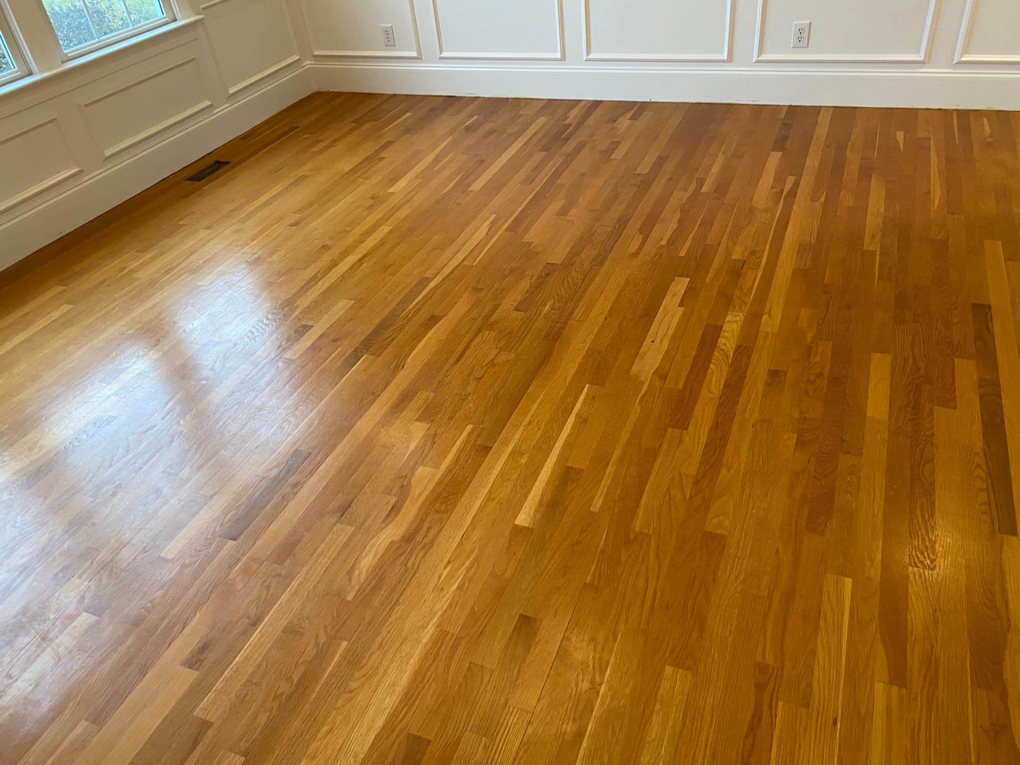 Dated orange-amber 2.25 inch white oak floors before refinishing in Heritage Wake Forest NC
