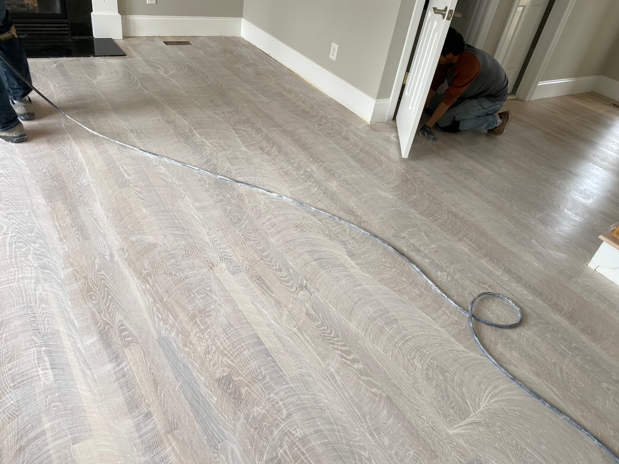 Spreading Bona Craft Oil Frost across white oak floor in Wake Forest NC