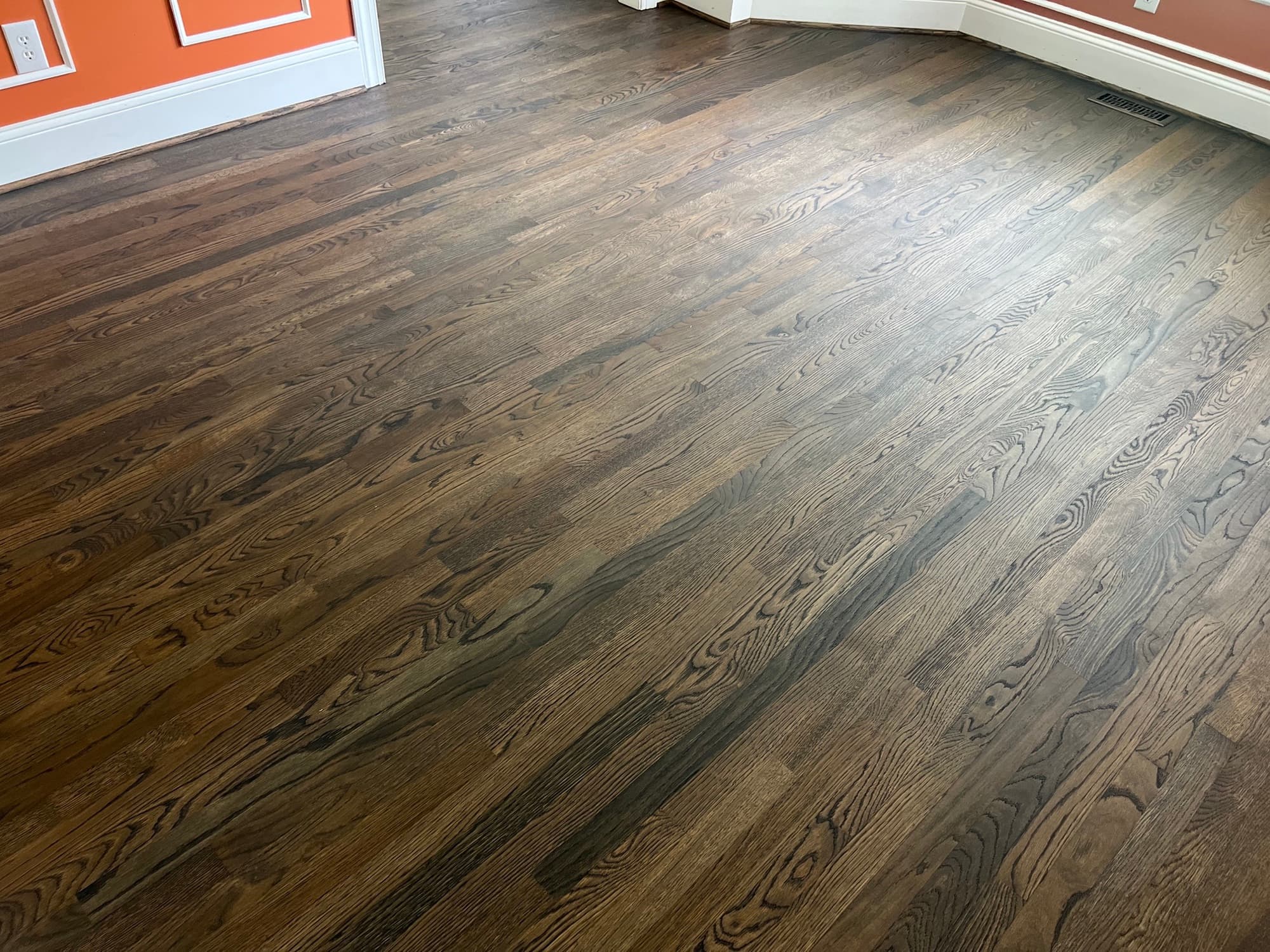 Finished white oak floors with custom blended hardwax oil throughout room in Ole Mill Stream Clayton NC, wide shot showing full field color consistency