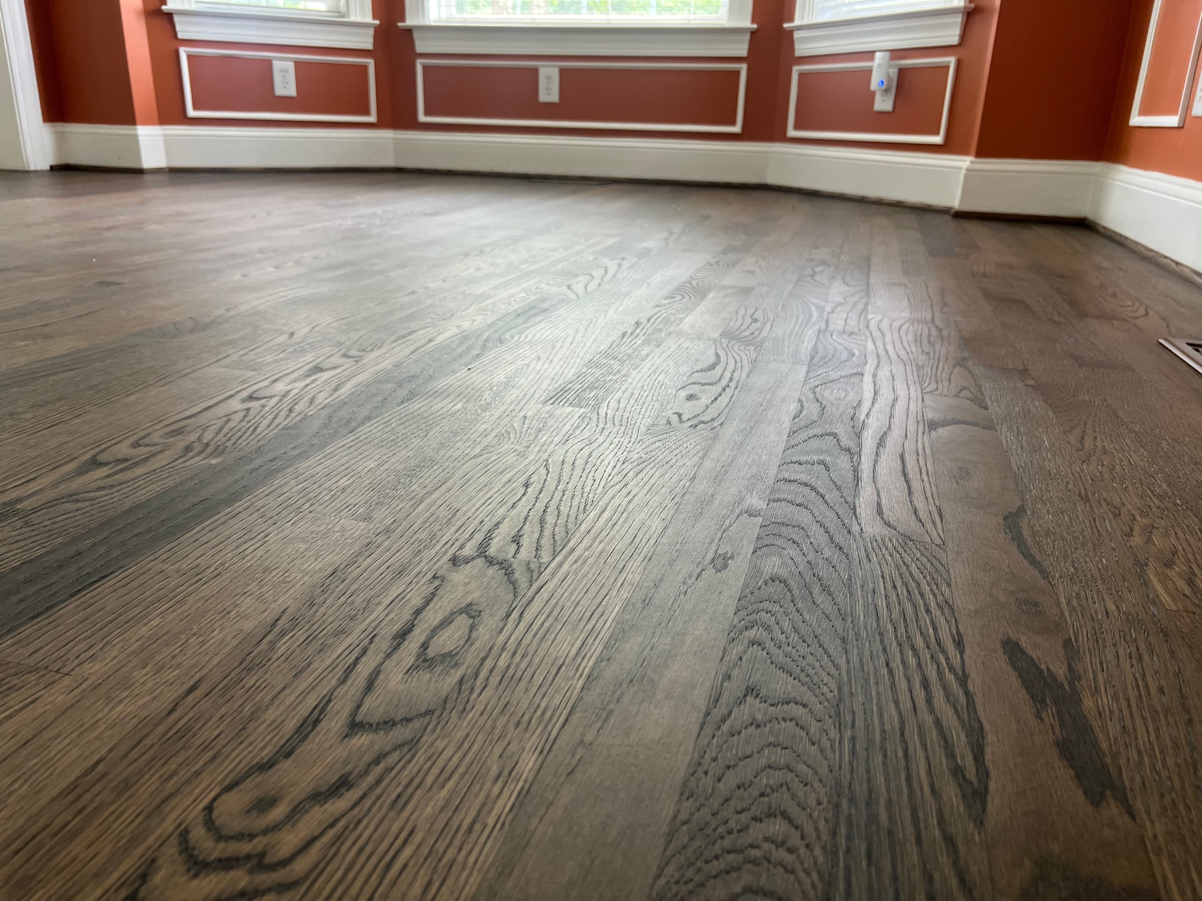 Finished 3.25 inch white oak floors with custom blended hardwax oil in Ole Mill Stream Clayton NC, cool dark tone matched to LVP in adjacent rooms
