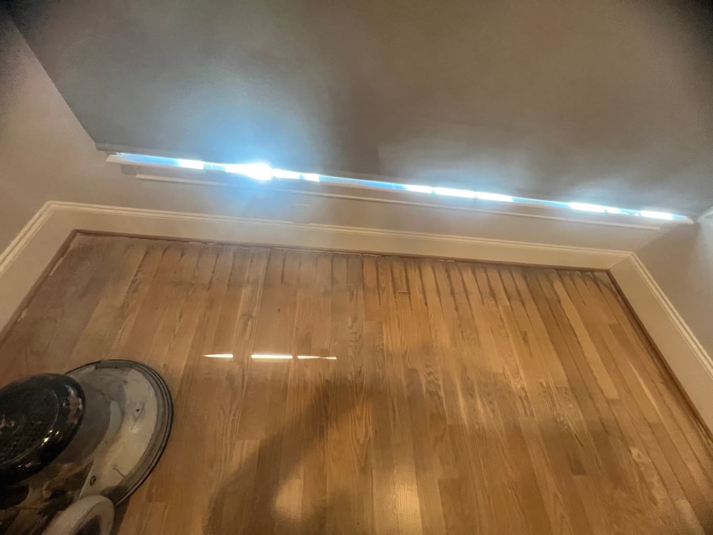 Sanded white oak floor in progress during rescue refinishing with natural light in room in Raleigh NC
