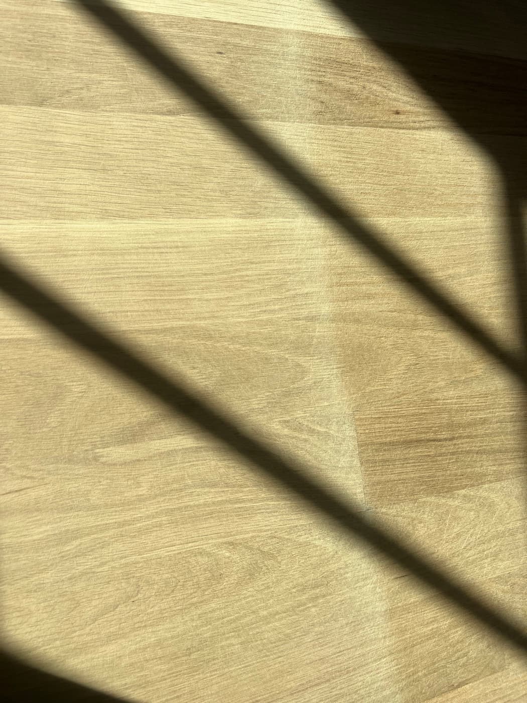Close-up of 3.25-inch white oak boards sanded bare showing clean grain detail before finish in Raleigh NC