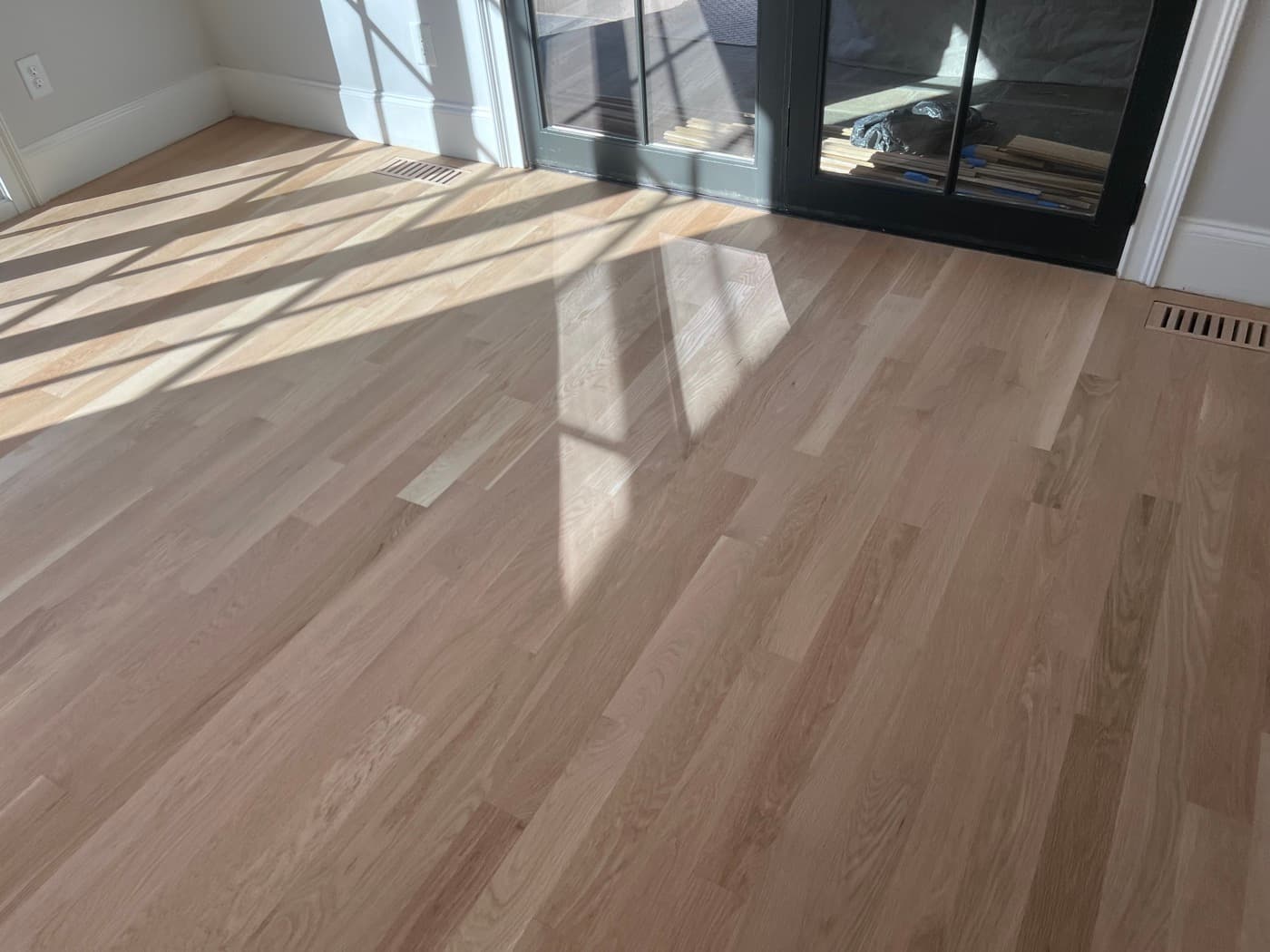 Addition and family room 3.25-inch white oak sanded bare before stain application in Hayes Barton Raleigh NC