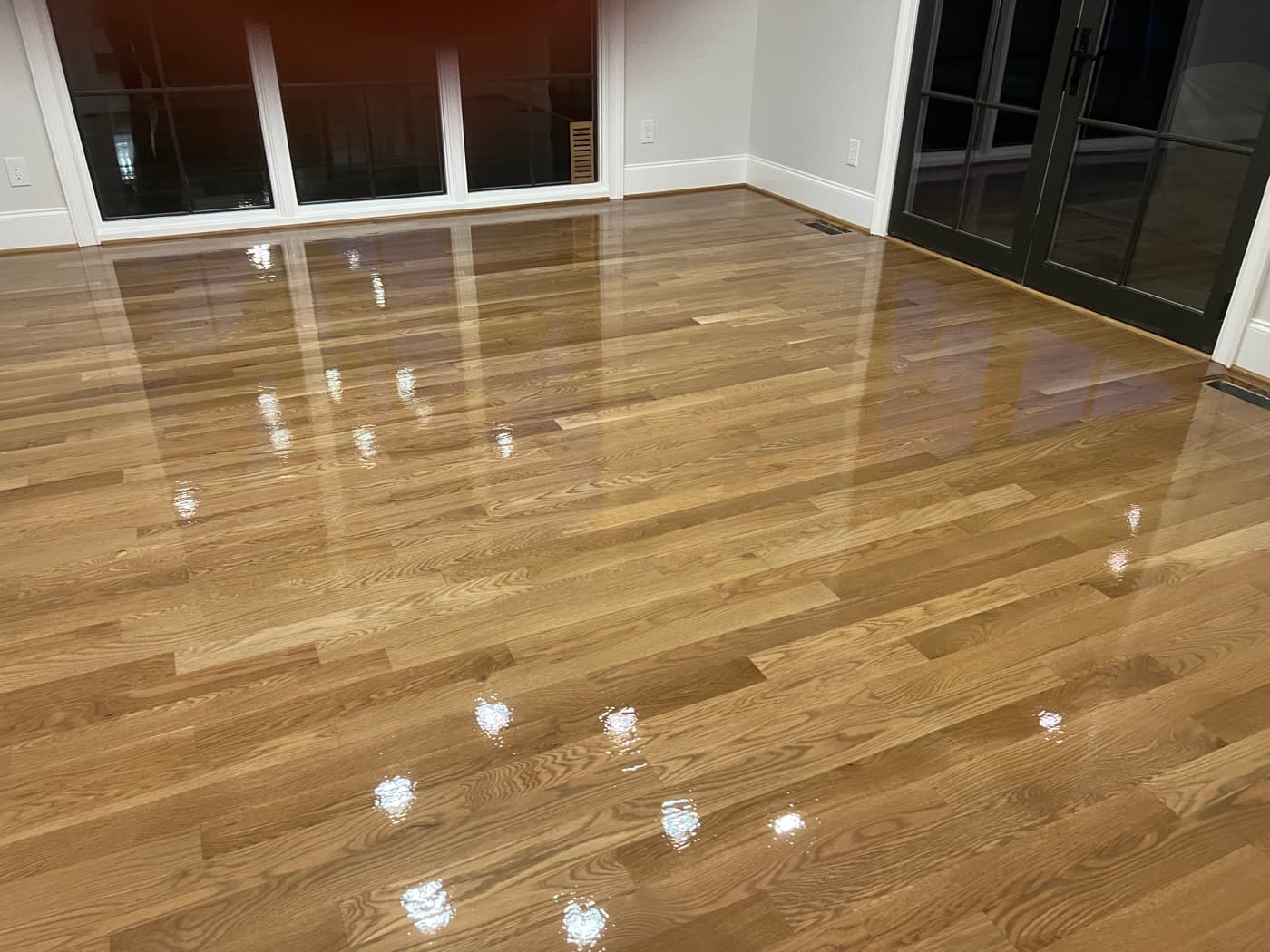 Bona ClearSeal first coat wet on white oak floors in evening light in Hayes Barton Raleigh NC